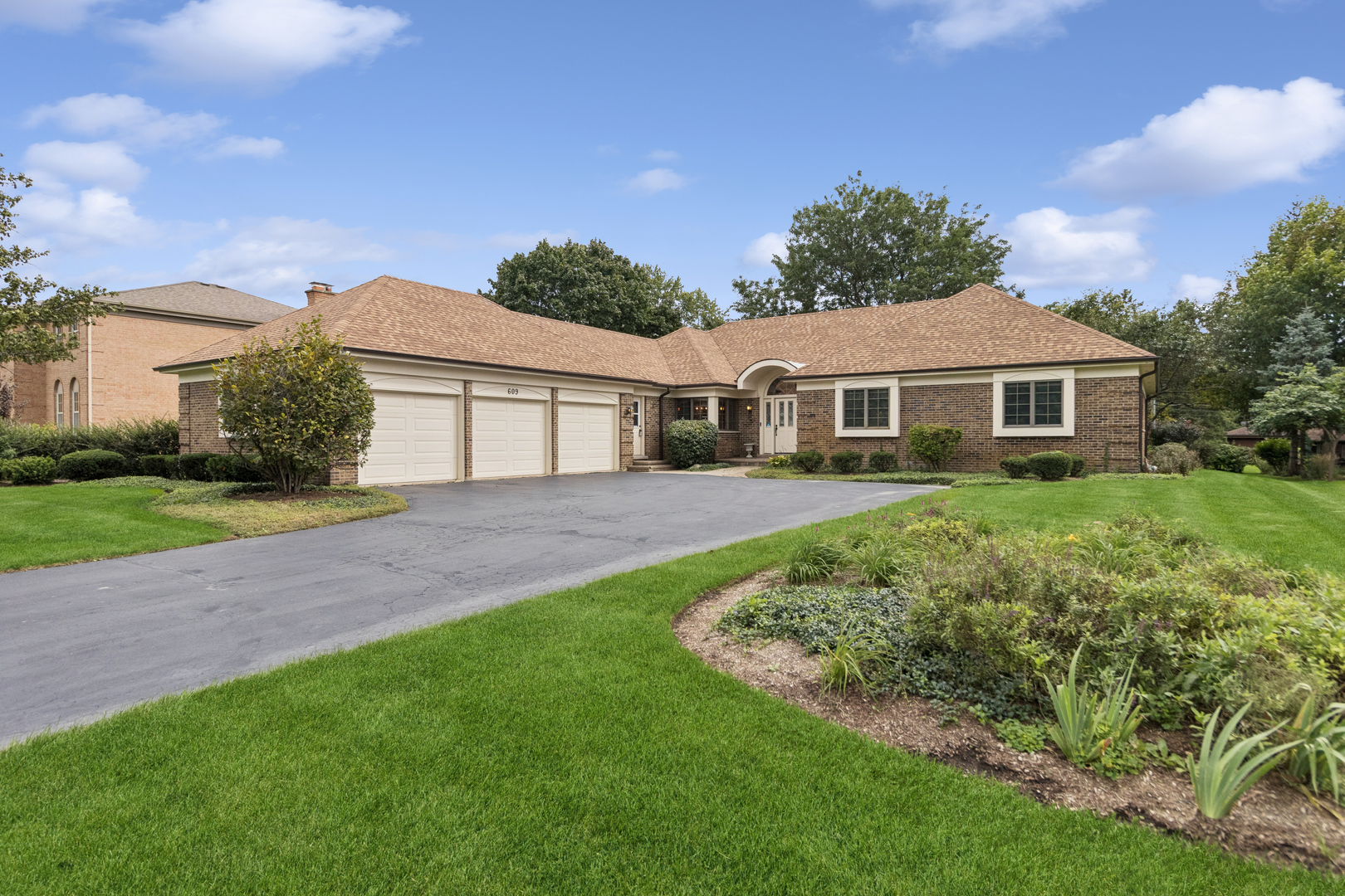 Impeccably maintained by its original owners, this timeless all-brick ranch in The Shires stands as a masterclass in pride of ownership. Situated on almost half an acre, this expansive 4-bedroom, 2-full and 2-half-bath residence combines premium custom construction with meticulous upkeep. Every square inch of this property reflects an elite level of care including major upgrades such as new roof and gutters (2025) with transferrable warranty, whole house generator, dual HVAC system with humidifiers and UV purifiers, sprinkler system, Lake Michigan drinking water with rented RO system and oversized 3-car garage. The remodeled eat-in kitchen features granite countertops, stainless steel appliances, farmhouse sink, soft-close cabinetry, pull-out shelves and built-in pantry. Opening to the kitchen is the inviting family room with tray ceiling, built-in bookshelves, gas-start fireplace and access to the brick paver patio and professionally landscaped yard. The primary suite includes two walk-in closets and a private bath with whirlpool tub and separate shower. The partially finished basement provides a large rec room, half bath, cedar closet, and abundant storage in the cement crawl. Additional storage, excellent for holiday decorations, is located in the garage pull-down attic. This home has been thoughtfully designed throughout for both everyday living and hosting and represents meticulous preservation and quality that is a rare find in today's market.
