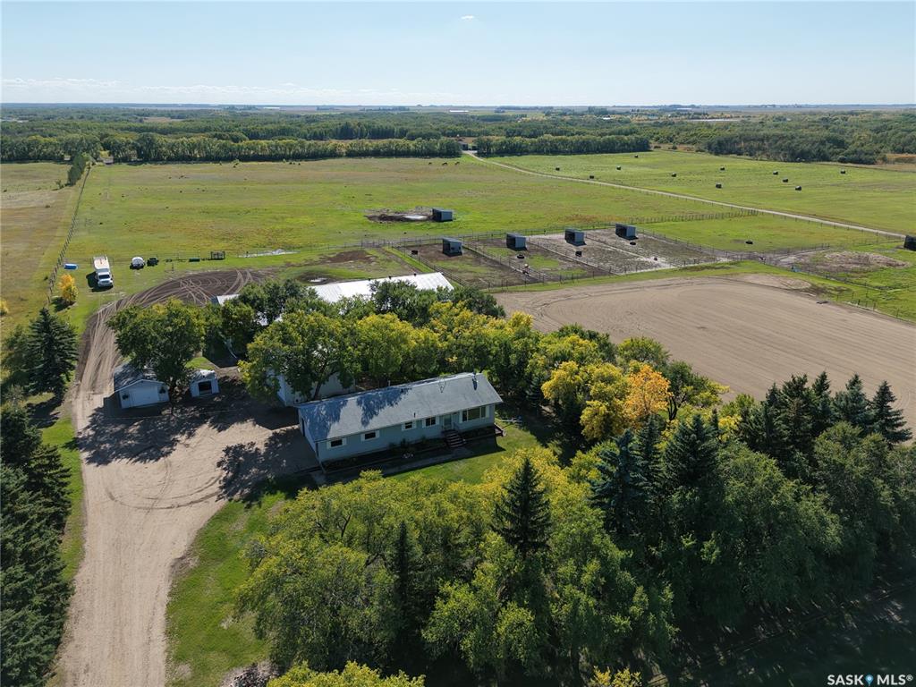 Premier 40-Acre Professional-Grade Horse Acreage on Pavement – Valley Road Area!Looking for a move-in ready professional-grade training, boarding, or private breeding setup 15 minutes from Saskatoon?Step into a masterfully designed, turn-key horse acreage tucked behind a private, coded security entry gate. Featuring an incredible 60' x 60' fully heated main barn seamlessly attached to a 60' x 60' 3-sided hay barn/machinery storage unit—offering a massive 7,200 sq. ft. continuous footprint. Bypass the skyrocketing costs of commercial constructionPremium Equestrian Infrastructure:The Heated Barn: Premium 60' x 60' fully heated main barn featuring 7 stalls, heavy-duty rubber tile flooring, a commercial floor drain, dual electric overhead doors, a dedicated tack room, laundry room, bathroom, meeting room, plus + softened hot & cold water system.Continuous Footprint Storage: Attached 60’ x 60’ 3-sided clear-span hay barn and machinery storage unit, delivering a massive 7,200 sq. ft. interconnected roofline.Fencing & Turnout: Extensively cross-fenced with premium, low-maintenance 3-rail pipe fencing. Optimized layout includes 8 distinct paddocks, 3 close pastures, a sprawling 13-acre fenced back pasture, rugged field shelters, and multiple automated heated water bowls.Training Grounds: Massive 180' x 350' outdoor riding arena professionally prepped with a deep, solid engineered base for elite year-round drainage and footing.Bonus Shop: Standalone 26' x 28' shop with 14-foot clearance ceilings for trailers/equipment.The Residential Asset:Relax in a solid, mechanically updated 1,100 sq. ft. 3-bed raised bungalow featuring a new furnace,  new central AC, and an open basement rough-in ready for immediate equity expansion, plus a 2-car attached residential garage. Move your horses in and operate on day one before winter hits!