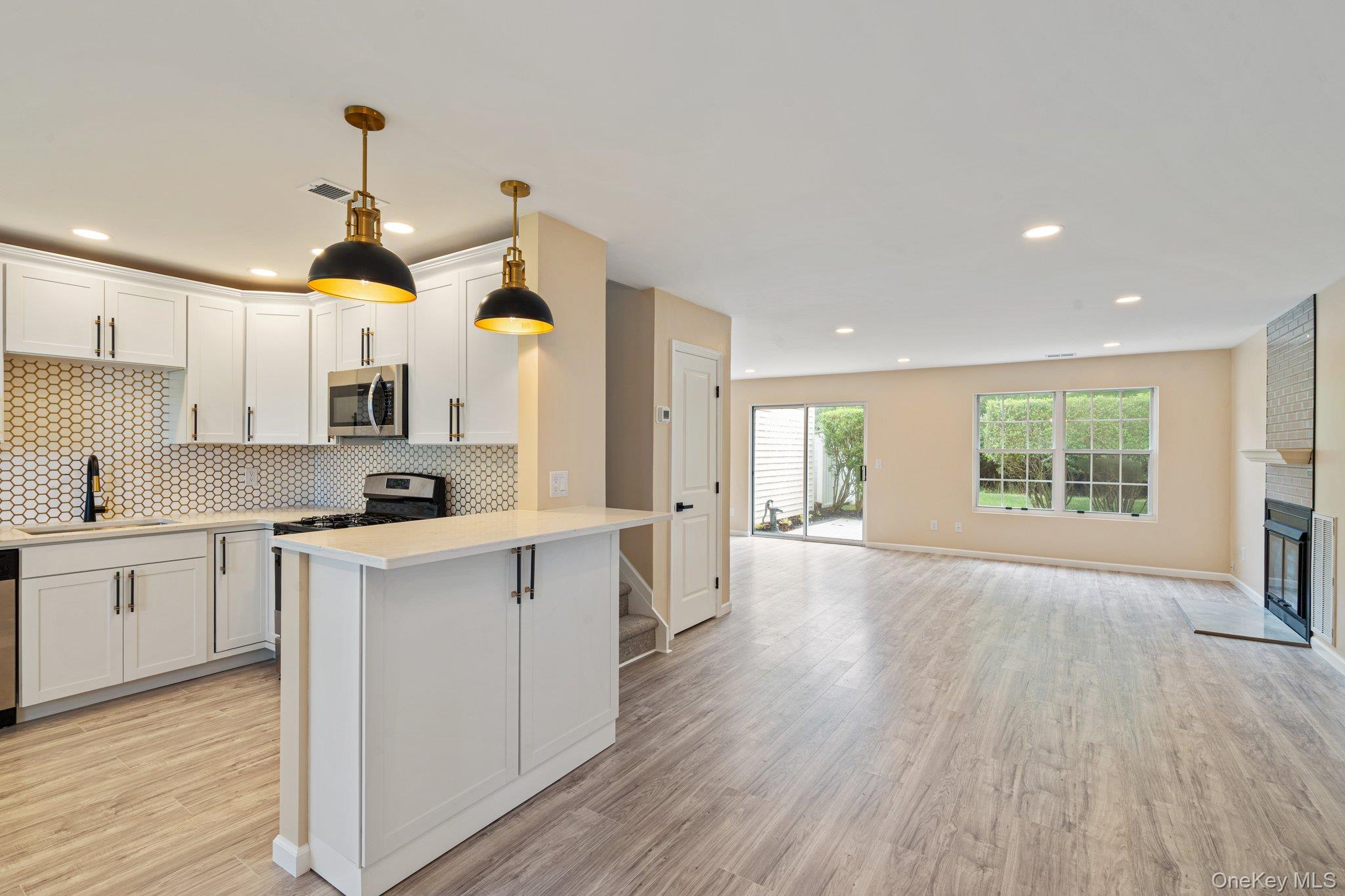 Discover Elevated Living In This Stunningly Updated Townhouse.  This Home Offers Three Spacious Bedrooms And 2.5 Beautifully Renovated Bathrooms Designed With Both Elegance And Comfort In Mind. At The Center Of The Home Is A Beautifully Updated Kitchen Featuring An Island, Contemporary Cabinetry, And High-End Finishes. It Opens Effortlessly Into A Bright, Open Living Area With A Relaxing Gas Fireplace That Is Perfect For Entertaining Guests Or Enjoying Quiet Nights At Home. Durable, Low-Maintenance Faux Wood Flooring Extends Throughout, Combining Style And Functionality. The Bathrooms Showcase Custom Tile Work And Upscale Designer Fixtures, Bringing A Spa Like Feel To Your Daily Routine. Step Outside To A Newly Crafted Private Patio, An Ideal Space For Morning Coffee, Outdoor Dining, Or Hosting Friends During The Summer Months. Beyond The Home, The Community Offers An Exceptional Lifestyle With Resort Style Amenities Including Tennis Courts, An Inground Pool With Lounging Area And Kiddie Pool, Basketball Court, Playground, Bocce Ball Court, Clubhouse, Fitness Center, Billiards And Paddle Ball Room, Plus A Bar And Party Space. Simply Move In And Begin Enjoying The Lifestyle You’ve Been Waiting For!