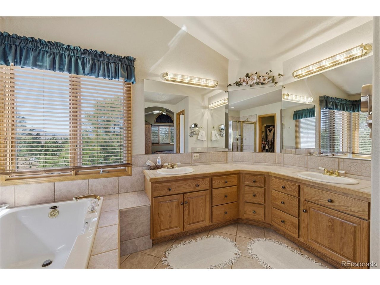 Stunning Custom Home offering 4,124 sq. ft. of beautifully designed living space, complete with a heated 24x36 Detached Shop & 3-car Insulated Garage WITH SPECTACULAR MOUNTAIN VIEWS! Built by BC Custom Homes. Lovingly maintained by the original owner, this property showcases quality craftsmanship & pride of ownership throughout. Step inside to soaring 10'-12' ceilings, a dramatic 17' living room, & floor-to-ceiling windows that flood the home with natural light. The grand entry features a sweeping staircase leading to a unique bridge-style upper level, creating a striking architectural focal point. The spacious Kitchen & Dining area offer expansive west-facing windows, Built-In Jenn Air Cook Top, full-length Breakfast Bar, Walk-in Pantry, & Schroll Custom Cabinets. The main floor also includes a versatile Office with Bay Window & closet (ideal as 4th Bedroom), plus a convenient guest bath. Upstairs, the Vaulted Primary Suite offers 10x12 Spa Like Retreat with a Soaking Tub, Separate Shower, & 12X6 Walk-in Closet. Additional bedrooms are oversized with ample storage, Large Closets & shared Full Bath. Finished Basement features tall ceilings, 30X37 REC ROOM, Built-In Wet Bar with Sink, Refrigerator, & Microwave-perfect for entertaining-along with abundant Storage, a 12X17 HOBBY ROOM , including a large 1/2 bath ready for a future steam shower. Recent updates include Brand New Class 4 Roof, newer Furnace (2 years), Exterior Paint (3 years), Central Air, Sprinkler System. Outdoor living shines with large Double Deck, private shaded Veranda, Tiered Flower Beds, nearly full fencing, and 30x10 Dog Run. Additional highlights include a Gas Line for grilling, powered Walkway Lighting, Electricity Post at the circular driveway. Located in a well-maintained community with newly improved roads, HOA services covering trash, snow removal, & seasonal clean-up, plus school bus access through the neighborhood, located on an exceptionally gorgeous setting!