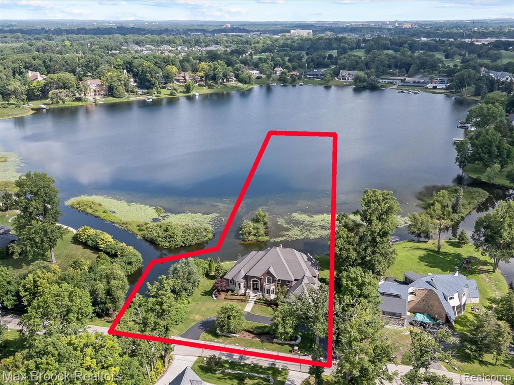 Welcome to 1456 Lochridge Rd. - A STUNNING BUILDER'S OWN MASTERPIECE perched on the edge of Forest Lake, offering breathtaking, sunset and sunrise views, approx 362" of water frontage, large backyard, and your own private island with birds and wildlife galore. This one-of-a-kind, luxury home, showcases, architectural excellence with crown moldings, tree ceilings, gleaming marble foyer, 3 gas fireplaces in panoramic lake views from the moment you step inside and from almost every room of the home. The main level boasts an entry level primary suite, panel library, great room, dining room and a gourmet kitchen with top-of-the-line appliances, a large island with seating space, a walk-in pantry, and an open concept player ideal for entertaining. The upper level has 3 en-suite bathrooms, plus a large, finished bonus space with room for add‘l bedrooms. The huge, finished lower walkout level offers a full wet bar, 2 large rooms with a sound system for entertaining, plus the theater room with surround sound and projector, and a spacious In-law suite or home office. Highlights include freshly refinished Brazilian cherry floors, new carpeting on the dual stairways and lower level, spa- like bathrooms, an entry chandelier that can rise or lower by switch and a home that shows like a new build throughout. The high-efficiency heating and cooling systems are zoned. Enjoy a true lakefront lifestyle with the ability to boat to Forest Lake Country Club and dock for dinner with membership. Best of both worlds: live on the quiet lake and have ability to boat on Lower Long and Upper Long Lake (an all sports lake). A RATE OPPORTUNITY TO OWN A PRIVATE LAKEFRONT RETREAT where thoughtful design, luxury finishes and breathtaking surroundings come together in perfect harmony. Highest ranked BLOOMFIELD HILLS SCHOOLS!