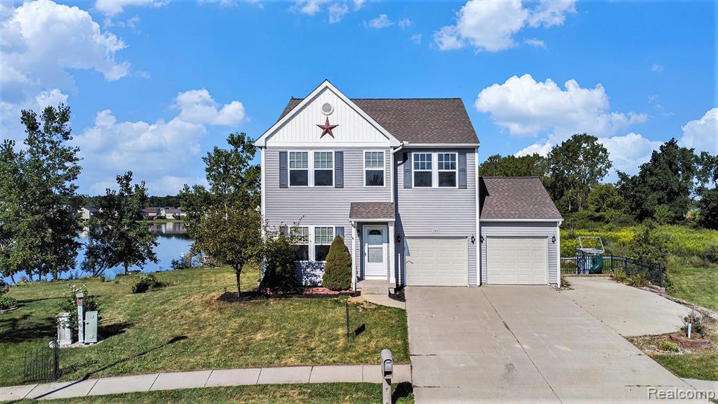 Welcome to this spacious LAKEFRONT home at 200 Lake Ridge Drive in Mason situated on the best lot in the sub! This 4 (possibly 5) bedroom, 3.5-bath house has everything you need, including a walk-out basement that leads directly to the lake. The main floor features an open-concept layout, perfect for entertaining. The kitchen has a bonus room and leads out to a steel TREX deck with lighting, offering a great view of the lake. Upstairs, you'll find four large bedrooms, including a sprawling primary suite with custom built-ins in the closet. There's also a second-floor laundry room. One bedroom is currently set up as a craft room/office with a built-in wrap-around desk. The finished basement includes a family room, guest room, and a full bath. A walk-out from the basement leads to an enclosed saltwater hot tub with screens and plexi inserts, so you can use it all year long. In addition to the two-car garage, there's a dedicated parking spot for a 40-foot RV, complete with a retaining wall and fence. Per the prior listing, a new roof was installed in May 2020. The waterfront area has a retaining wall and a bench, perfect for enjoying the lake. The monthly HOA fee covers the community water system, along with lake and road maintenance. Easy to view and immediate occupancy!!