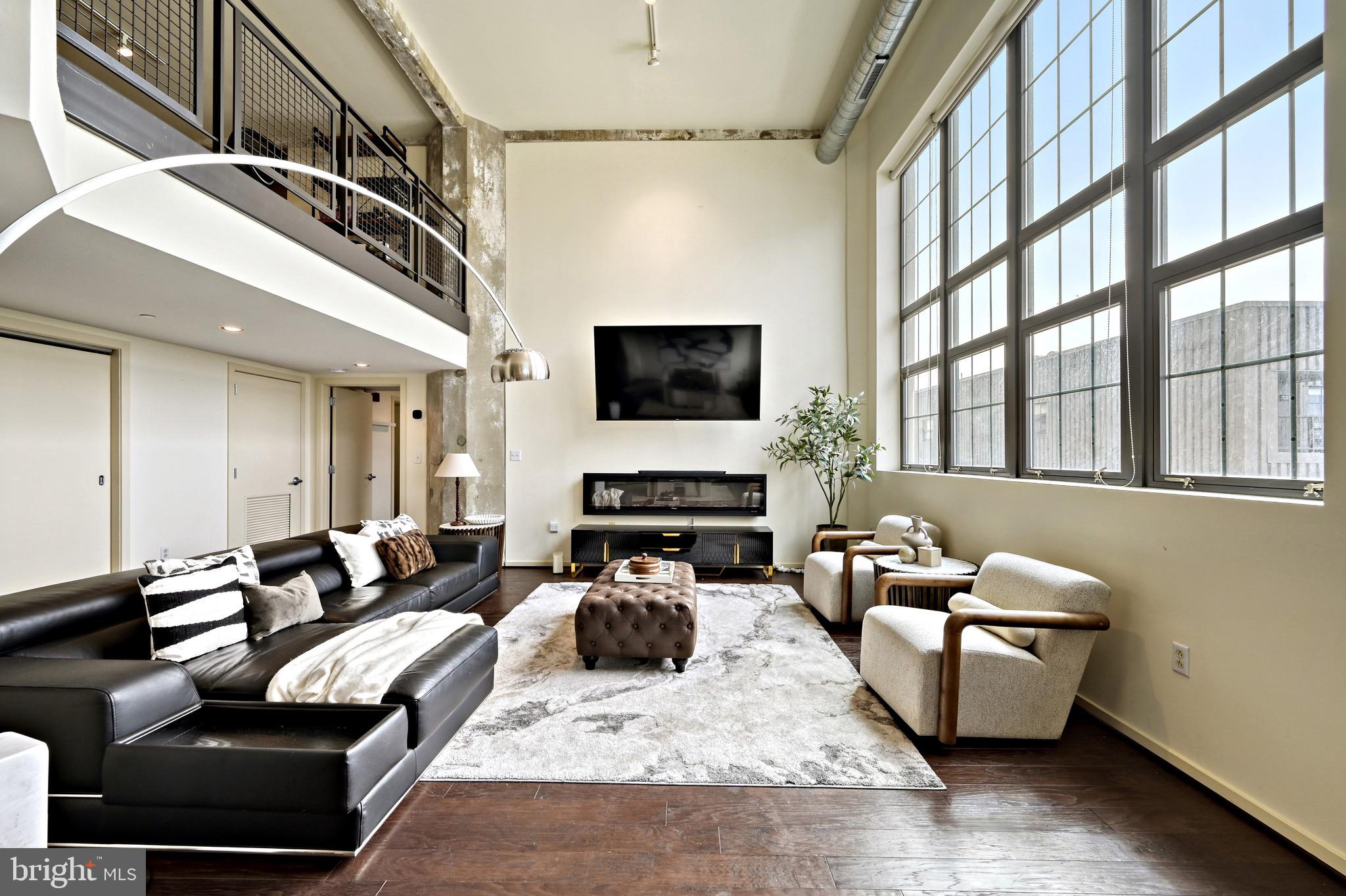 Experience elevated living in this architecturally stunning Silo Point Tower residence. This expansive three-bedroom, three-and-a-half-bath plus loft industrial loft-style condominium offers over 2,700 square feet of light-filled living space. Designed for both style and function, the open floor plan showcases soaring ceilings, walls of glass, and rich hardwood floors, complemented by exposed ductwork, concrete columns/ceilings, and steel accents. The gourmet kitchen, complete with an island and breakfast bar, flows seamlessly into the living and dining areas, perfect for entertaining. Thoughtful upgrades, including Lutron blinds and custom closets, enhance the home’s sophisticated appeal. Two secured, assigned parking spaces complete this exceptional offering. Residents of Silo Point enjoy premier full-service amenities, including a 24-hour concierge, a state-of-the-art fitness center with an adjoining yoga studio and private treatment room, a boardroom, a game room, and access to the exclusive 19th-floor Sky Lounge, offering breathtaking city and waterfront views.