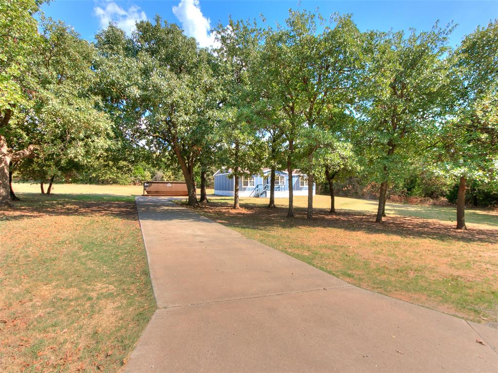 This 3-bedroom, 2-bath home sits on approximately 1.25 acres in North Edmond, offering plenty of outdoor space and a tree-lined setting. Inside, you’ll find an open living area, wood-look flooring throughout, and a spacious kitchen with plenty of cabinet and counter space. The primary suite includes a private bathroom with double vanities, a separate shower, and a corner tub. Outside, the property offers a front deck, mature trees, and room for parking, pets, a garden, or future improvements. A good option for anyone looking for more land at a great price while staying within easy reach of Edmond.