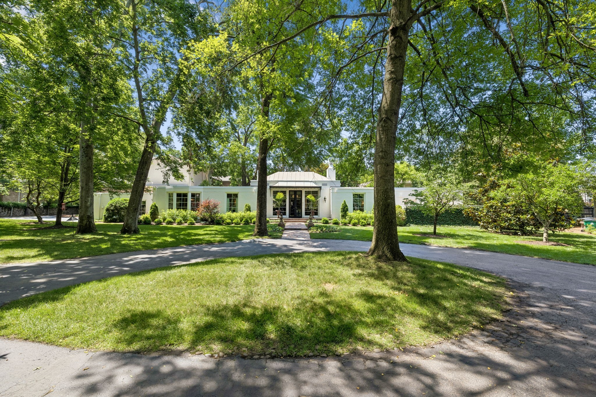 A rare opportunity to own a piece of Nashville architectural history. This distinguished 1940 Edwin Keeble residence is nestled within an intimate enclave of seven homes, quietly tucked away in the back of the community in a park like setting. At 4,122 sq. ft., the home offers 4 bedrooms and 4.5 bathrooms, with 3 fireplaces. While the home is historic, the updates are modern including GE Cafe stainless appliances in the kitchen (2025), replaced plumbing throughout the crawl space (2026), hardwood floors refinished (2025), updated ductwork, new Marvin windows (2020), dual HVAC units(2015 and 2017), and multiple roof sections replaced between 2018-2025. Enjoy sitting on one of the 3 patio including the walled private patio outside the primary bedroom. The primary bathroom includes custom his and her walk-in closets and large marble shower. A must see!