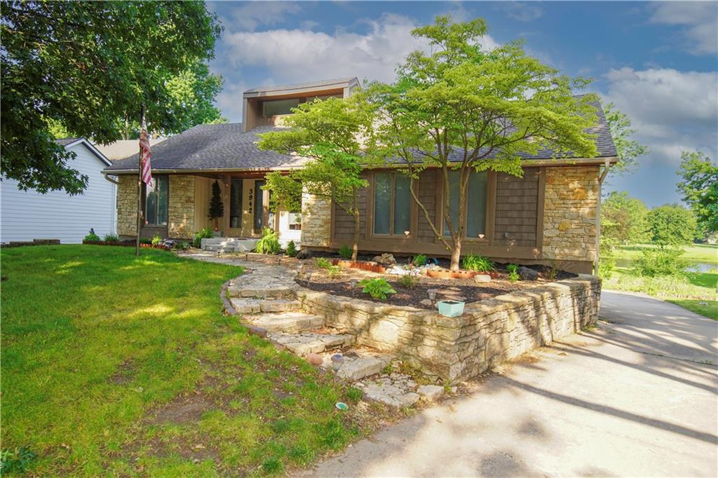 Lakefront location w/incredible views!   Enter the home from the cozy front porch into the open concept living room with vaulted ceilings and stone fireplace, large eat in kitchen with plenty of cabinet space & stainless appliances, eat in area leads to large deck & beautiful scenery.  Formal dining room as well, laundry on main bedroom level, master bedroom w/deck access & attached updated master bath.  Finished walkout basement w/2nd fireplace, half bathroom, non conforming 4th bedroom, & additional work out room with steam shower,  One side of garage is tandem & would work great for fishing boat storage, lots of additional parking in rear of home. Swim dock and neighborhood pool is within walking distance. Fresh interior paint in 2025 & HVAC is less than 1 year old w/transferrable warranty.  Seller is motivated w/terms!