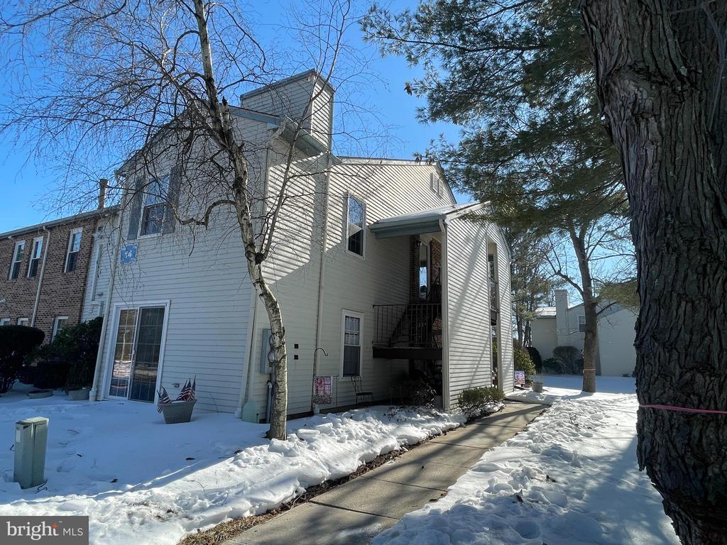 Nestled in the heart of the highly sought-after 55+ Holiday Village community, 112 Village Ln offers an exceptional opportunity for active adults seeking a blend of comfort and convenience. This beautifully maintained second-floor condo features an inviting open-concept layout, where the spacious living and dining areas flow naturally toward the home’s crowning jewel: a sun-drenched sunroom. With the sunroom's wall of picturesque windows, this versatile space provides serene views of the community’s lush, mature landscaping and serves as the perfect spot for morning coffee, a quiet reading nook, an office, or an extra space for visitors with a room divider.The interior is designed for easy living, highlighted by an updated eat-in kitchen equipped with a gas stove, built-in microwave, and ample cabinetry for the home chef. Both of the generous bedrooms offer a peaceful retreat, particularly the primary suite which features private bath access and two large closets for belongings and storage. Practicality meets peace of mind here as well, with significant mechanical updates with a meticulously maintained and serviced HVAC system and a newer water heater, ensuring comfort through every season.Beyond the front door, the Holiday Village lifestyle provides a vibrant social atmosphere and a wealth of amenities. Residents enjoy access to a lively clubhouse featuring a fitness center, billiards, and card rooms, while the outdoor grounds boast a heated pool, tennis courts, and scenic walking paths. Ideally located within walking distance of local shopping and just minutes from major arteries like Route 295 and the NJ Turnpike, this home perfectly balances a quiet residential feel with effortless access to Philadelphia and the Jersey Shore.