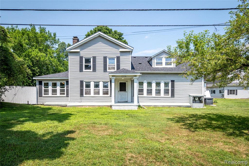 Don’t miss this rare opportunity to own nearly 5 acres with a distinctive 6-bedroom, 3-bathroom Greek Revival home with multiple large outbuildings. Whether you need space for your hobbies or business, this is a truly unique property. The home is currently set up as two units that could serve a multi-generational family or as an investment opportunity. The one closest outbuilding to the home is set up with another living space and has a basement. The building behind it features a loading dock area with a large roll-up door and potential shop space or storage in the back half of the building. It now includes a large loading dock with 3 roll up doors. The third building to the west also has large doors and is divided into two spaces suited for a variety of uses. The 4.77 acres is made up of two parcels (0.89 and 3.88 acres, with the house on the larger parcel) perfectly situated on just over 4 scenic acres. This property is serviced by both sewer and city water. This remarkable property offers a blend of classic character and expansive potential, ready for you to make it your own. Step inside to discover generously sized living areas that flow seamlessly from room to room, ideal for both comfortable everyday living and large gatherings. The spacious kitchen is a true centerpiece, featuring ample cabinetry, expansive countertop space, and a functional island, perfect for preparing meals and entertaining guests. This home also includes a well-appointed mother-in-law suite, offering flexibility for multi-generational living, guest accommodations, or additional private space tailored to your lifestyle needs. Outside, the property is enhanced by several outbuildings, ideal for storage, office space, workshops, or any number of creative uses. Whether you're looking for space to grow, work, or unwind, this property delivers both charm and functionality. Schedule your private showing today and explore the full potential of this truly special home.