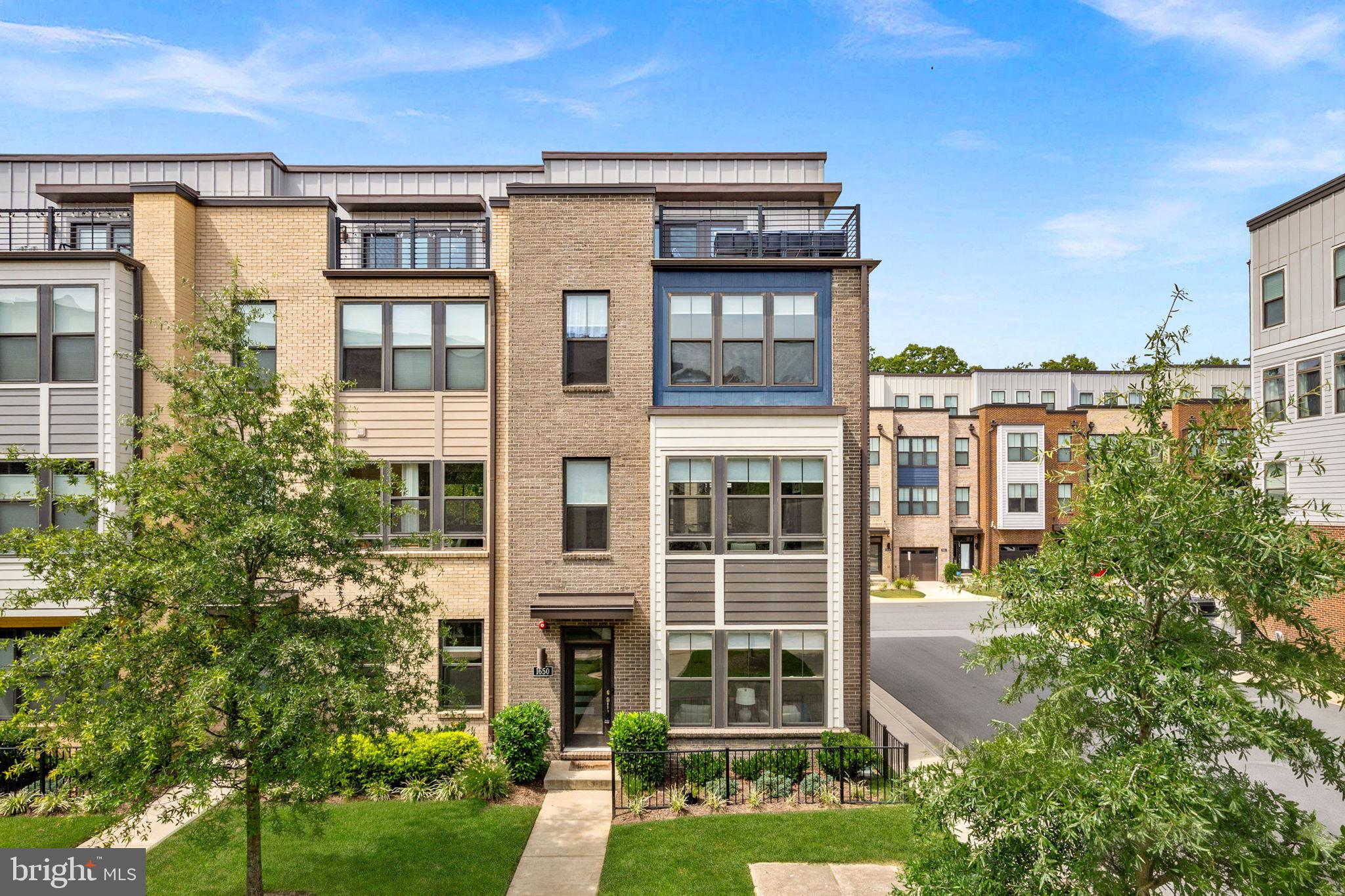 This is the home you've been waiting for! Enjoy four levels of luxury living space, a kitchen so stunning it stops people in their tracks, a private balcony for your morning coffee, and a rooftop terrace for sunset cocktails. Every single bedroom comes with its own walk in closet. And the location? Ideal! You are just one mile from the Wiehle Reston Metro and two miles from Reston Town Center. You have full access to everything the Reston Association has to offer, including lake privileges, 50 miles of nature trails, 15 pools, tennis and pickleball courts, and so much more. This is more than a townhome. It is a lifestyle.This end unit townhome is a standout, offering elevated design and an unbeatable commuter location. Just six years young and freshly painted throughout, it feels brand new. A beautiful entry welcomes you into a light filled flex space, customizable for whatever you need, whether that is a home office, exercise studio, or lounge. You are surrounded by windows overlooking the lush courtyard, where the all of the landscaping is taken care of for you. From here, you have direct access to the two car garage and additional two car driveway.The main level is beautifully appointed with a light-filled open-concept layout. The spacious living room centers on a fireplace and extends effortlessly to a private deck, made for morning coffee or evening entertaining. At the heart of it all, a chef caliber kitchen commands attention with a waterfall edge quartz island, custom cabinetry, a designer tile backsplash, stainless steel appliances, double wall ovens, two pantries and gas cooking. This space is built to impress as much as it is built to cook in. A lovely dining room and a convenient but private powder room complete the level.Retreat to the third floor, where the primary suite offers a true owner's escape: a spacious walk in closet and a spa inspired ensuite bath with a dual vanity, dark wood cabinetry, and an oversized frameless glass shower. Down the hall, a second bedroom offers its own full bath and walk-in closet, and the laundry is conveniently on this level too.At the top of the home, the versatile fourth level offers a third bedroom with it's own a full bath and walk-in closet, and another bonus flex space, perfect for a media room or additional rec space. This leads you to the crown jewel of the residence: a rooftop terrace made for entertaining under the stars.Outdoor living continues well beyond the home itself. The property sits adjacent to the Reston Blue Trail, with the Tall Oaks swimming pool just across the street. You are just 2 miles from Reston Town Center and 5 miles from Dulles International Airport.This is a beautiful home in an ideal location and a wonderful place to call home. Schedule a tour today!