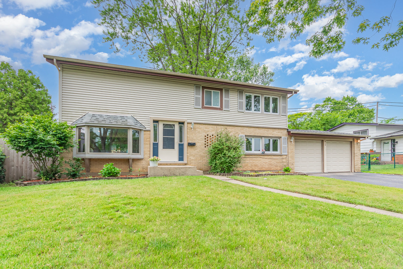 Welcome to 413 North Shore Dr in Mundelein, a charming single-family home just a 5-minute walk from beautiful Diamond Lake. With 5 spacious bedrooms upstairs, including a professionally permitted remodel completed in 2003 (note: the 5th bedroom will need a closet), this home offers versatility for growing needs. Enjoy a warm and inviting open layout featuring a bright bay window in the front living area, brand new carpet throughout the entire upstairs, and fresh paint throughout. The fully remodeled kitchen (2020) is a standout with quartz countertops, stainless steel appliances, and modern finishes, perfect for everyday living and entertaining. Hardwood floors run throughout the entire home, including under the new carpet upstairs. There are two full bathrooms, one on the main level and one upstairs, offering convenience for guests. Step outside to a fully fenced backyard with a patio, perfect for summer gatherings, and a storage shed for extra space. The home sits on a 0.22-acre lot and includes an attached 2-car garage. Other highlights include a roof approximately 10 years old, a permitted room addition completed in 2003 by professional contractors, and a permitted shed. Located less than a mile from the train station for easy city commuting and close to the Mundelein Park District and local amenities. This home is ideal for anyone looking to settle into a well-maintained, move-in-ready space in a desirable location near the lake.