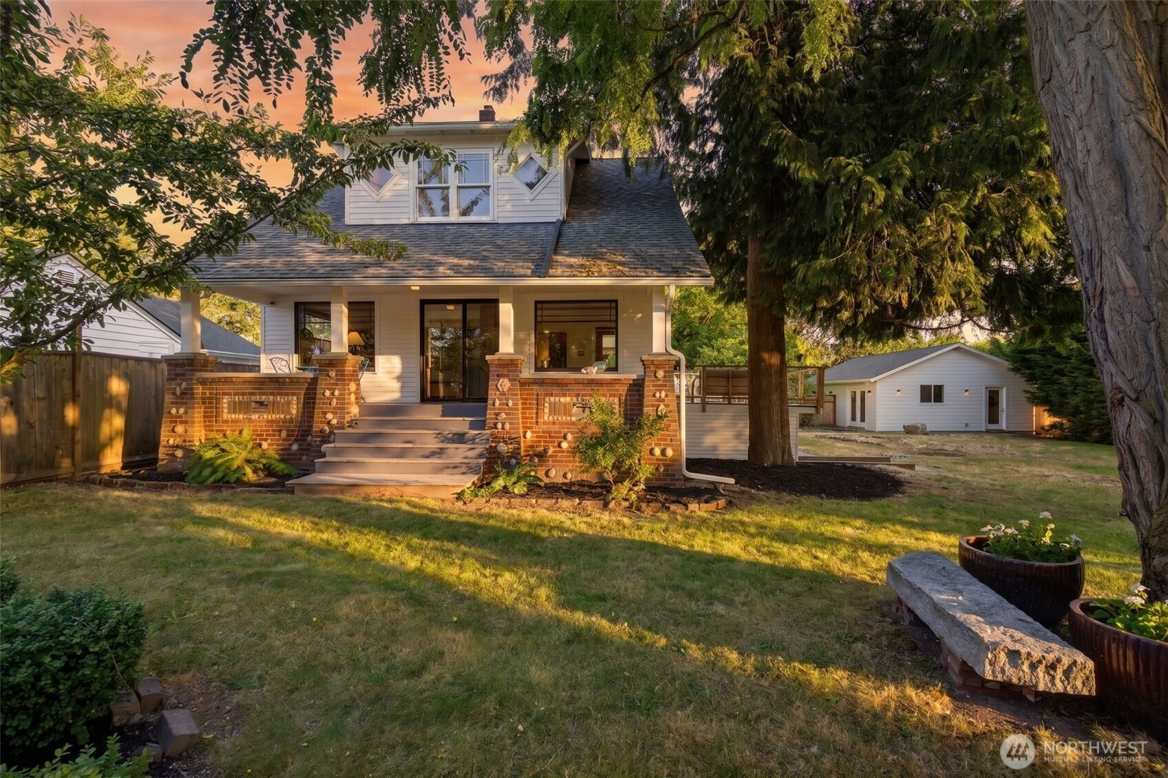 Shangri-La. A 2891sqft Farmhouse with two huge finished outbuildings (512sqft and 720sqft!) on a 18400sqft lot. How can a place be so relaxing and invigorating at the same time? Arriving home, you are held within the symmetry of the two out buildings, the privacy of the tree lined grounds, and the stunningly gorgeous farmhouse waiting expectantly for you to enter. This is a home and yard built for serenity, projects, socializing, and growth. The house has an intimate west facing covered porch off the living room. And an oversized southern deck off the dining room begging for its next BBQ. With the circular floor plan and central stairs you can move through the house with ease. 2 big bedrooms with walk-in closets and a 5-piece bath upstairs. 3 sprawling daylight bedrooms and a spa downstairs. 1921 Charm, this house is in excellent condition and has withstood the test of time. The 2 out buildings are new, solid, and very large. Music, ceremony, office, personal practice, or guest house or garage? You make the choice! Play world cup inspired soccer on the enormous flat yard and still have room for tomatoes and dahlias and fruit trees. Past Present and Future Luminaries of Seattle's iconic music arts and spiritual community have graced this land! This is a once in a generation opportunity for a generational investment! Easy walk to central Columbia City and light rail. 8 parking spots.