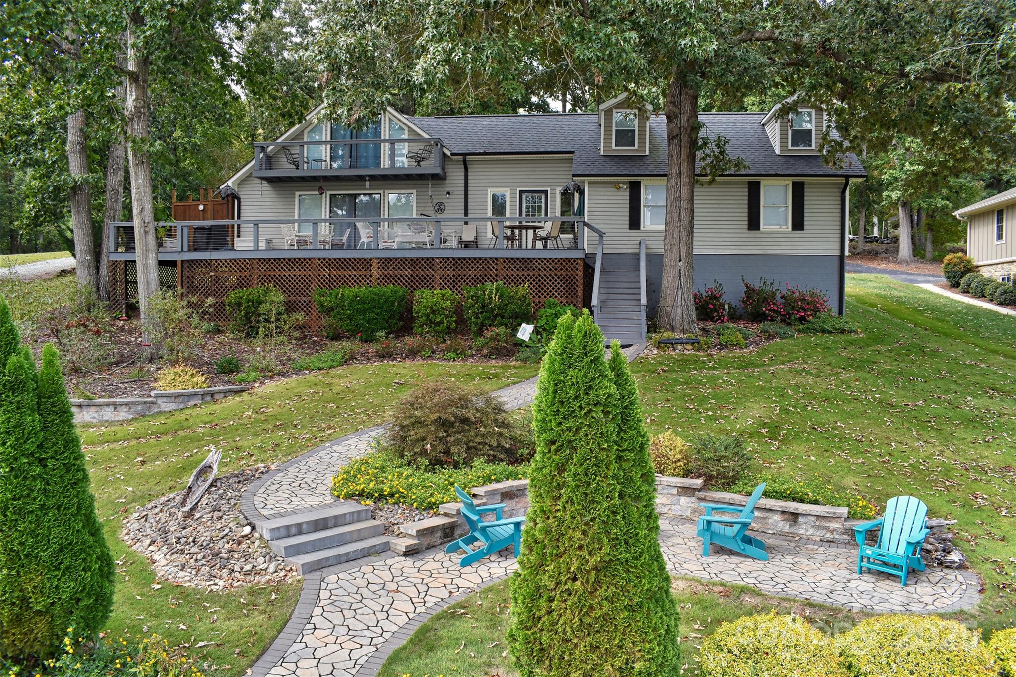 This waterfront home is located off Badin Lake's main channel. Near the mouth of a desirable deep-water cove between Sunrise Point & Dixie Shores. Large .55 acre lot in the peaceful little Sunrise Point area (Lot #1). Recently remodeled home. The main level features a kitchen, living room & dining room with fantastic views. Open kitchen & living area. Granite counter tops. Large lakeview deck & grilling area. Fully shaded deck makes it perfect for families during the hot summers. Cape Cod outdoor shower. Laundry on main. The upper level features 2 bedrooms, a lakefront balcony, game room & office.
Huge stationary pier with covered boat slip & heavy lift, 2 covered jet ski slips & grandfathered upper sundeck. Ideal for swimming & fishing, away from heavy boat traffic. Main channel views. Plenty of shaded area under the pier sundeck for relaxing with the steady breeze that comes through the cove regularly. Seawall that spans the 113 feet of waterfrontage. Fully manicured front lawn with Zoysia grass, stone walkways & large stone walls with lakeside fire pit in front. Stone walls with large planter beds in the rear with fruit trees & Crepe Myrtles throughout. Some furniture negotiable. Pontoon boat negotiable-ask listing office for details. County water & sewer. Circular asphalt driveway; plenty of parking. Paved, public Whip O Will Wildlife boat landing within the neighborhood. Convenient to the lake’s marinas that provide dining, gas & watercraft rentals. The Uwharrie National Forest 5 minutes away is a great destination for camping, hiking, horseback riding & ATV/OHV trails. Within 1 hour from Charlotte, Greensboro or Winston-Salem.