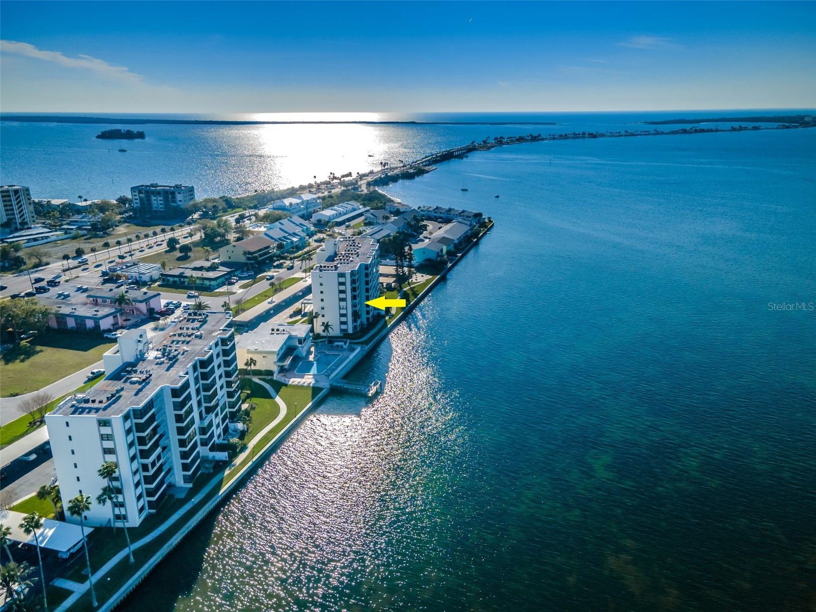 Experience the Best of Waterfront Living in Dunedin! Wake up to breathtaking views of St. Joseph Sound and the Gulf of Mexico in this beautifully updated, end-unit condominium, where coastal charm meets effortless Florida living. Offering 1,375 square feet, two bedrooms, two baths and a desirable split-bedroom floor plan, this inviting residence combines privacy, comfort and spectacular water views. Step onto your private balcony, sip your morning coffee, and watch dolphins play in the sparkling waters or unwind in the evening as the sun paints the sky with unforgettable sunsets. The light and airy interior features an open-concept design and a beautifully remodeled kitchen with crisp white shaker cabinetry, elegant quartz countertops, and modern stainless-steel appliances. Both bathrooms have been tastefully updated, while attractive luxury vinyl plank flooring and classic six-panel interior doors add style throughout. A full-size stackable washer and dryer provide everyday convenience, and the home also includes an assigned covered parking space and additional storage just down the hall. Resort-Style amenities include an oversized clubhouse featuring a well-appointed kitchen, comfortable gathering spaces, a fireplace and an exercise room. Take a refreshing dip in the heated pool, fire up the gas grill, or enjoy the waterfront lifestyle with a fishing dock and pier, kayak rack, and bicycle storage. Whether you're seeking relaxation, recreation, or a welcoming place to connect with neighbors, this community offers something for everyone. An Unbeatable Dunedin Location! Enjoy the best of the Florida coastal lifestyle with easy access to the Pinellas Trail, Dunedin Causeway and beautiful Honeymoon Island State Park. Explore charming Downtown Dunedin's popular restaurants, breweries, boutiques, and local events, with Clearwater, Palm Harbor, Safety Harbor, and Tarpon Springs all nearby. The HOA fee includes water, sewer, trash, basic cable, internet, pest control, exterior building maintenance, escrow reserves, and property management, adding convenience and value. Whether you're searching for a year-round residence or a relaxing vacation retreat, this exceptional condo is a special opportunity!