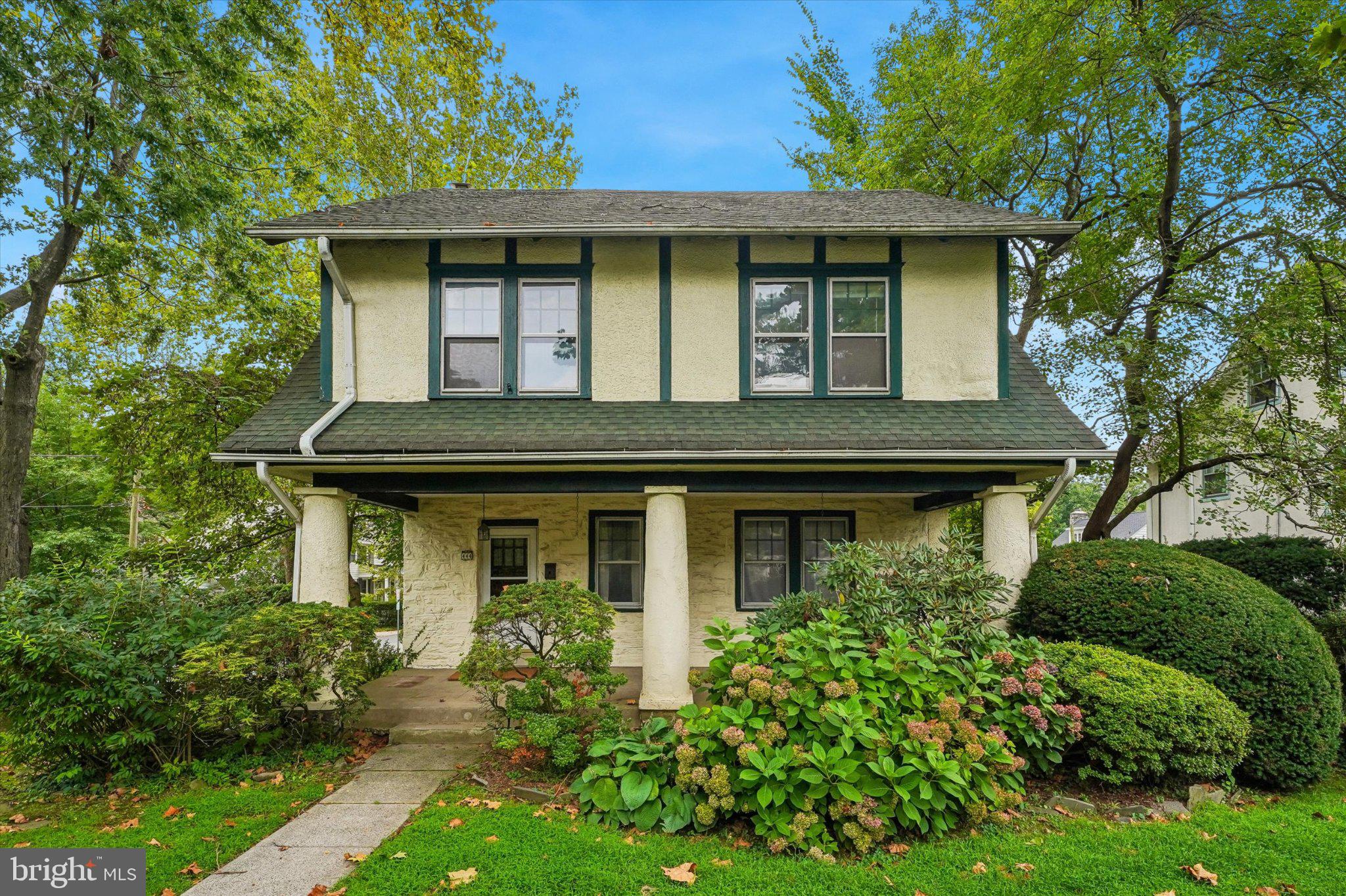 A rare opportunity on the corner everyone knows - six bedrooms on one of Merion Station's landmark lots. Set on a prominent corner in highly desirable Lower Merion Township, this distinguished 1925 Merion Station colonial offers classic architectural character, generous proportions, and exceptional potential. A broad, covered front porch welcomes you and sets the tone for a home defined by original details and thoughtful layout. Step inside to discover beautifully inlaid hardwood floors, a striking stone fireplace that anchors the living room, and both front and rear staircases that speak to the home’s timeless design and flow.The main level provides gracious, well-proportioned rooms for everyday living and entertaining. The oversized living room is bright and inviting, with expansive sight lines to the fireplace and porch. A formal dining room provides the perfect backdrop for dinner parties and holiday gatherings. The kitchen, complete with a handy pantry, opens to a mud/laundry room and powder room for convenience. The kitchen leads to a large, elevated deck overlooking the private rear yard—an ideal setting for al fresco dining, summer barbecues, container gardening, or quiet morning coffee.Upstairs, the second floor features four spacious bedrooms, one of which includes a sunroom, and a full hall bath with tub/shower, offering comfortable family quarters and ample closet space. The third floor adds two additional bedrooms and a full bath with shower, creating flexible accommodations for guests, a home office, a studio, or multi-generational living. These upper levels deliver flexible configurations to suit evolving needs—work-from-home setups, hobby spaces, or private guest suites.The fully waterproofed basement provides abundant storage space and peace of mind, making it ideal for organizing seasonal items, hobbies, or workshop space. Sewer exit pipe was relined. Outside, the property includes a detached two-car garage and a private driveway accessed from Oak Road that accommodates up to four cars—rare convenience for the Main Line. The corner lot provides generous outdoor space with room for gardens, play areas, and future landscape improvements.Location is outstanding: in one of the Main Line’s most sought-after neighborhoods and within easy walking distance of Narberth train station for effortless commuting into the city. Enjoy nearby shops, cafés, and restaurants in Narberth and Bala Cynwyd, plus close proximity to parks, highly regarded schools, and major commuting routes.This classic home combines enduring architectural charm, spacious living areas, and an enviable location with the opportunity to renovate, restore, or thoughtfully update to your tastes. Whether you envision preserving its historic integrity or creating a modernized dream home, this Lower Merion gem is a rare opportunity to craft the next chapter on a beautiful Main Line corner lot.