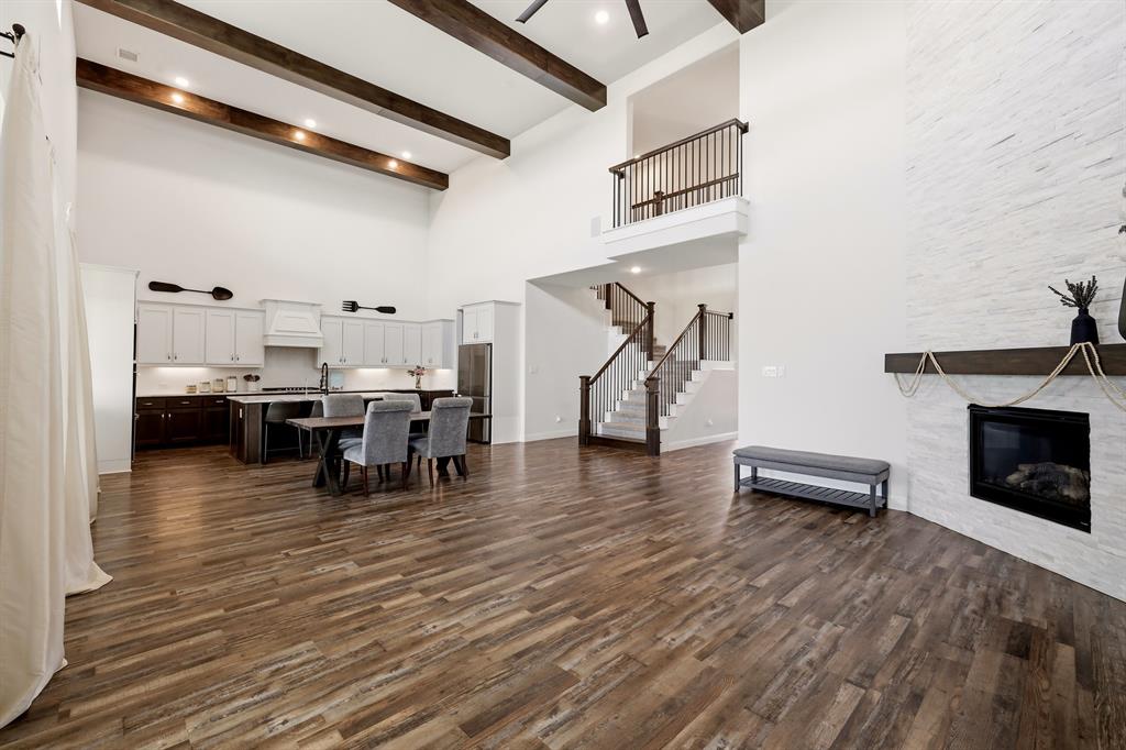 Welcome to this beautifully upgraded 2021-built home in Gideon Grove North, perfectly positioned on a landscaped 0.23-acre lot with expansive greenbelt views and no immediate rear neighbors. Offering 3,467 square feet, 4 bedrooms, 4.5 baths, a game room, office, and a desirable J-swing 3-car garage, this home was thoughtfully designed for both comfortable everyday living and grand entertaining.  Inside, soaring 20-foot ceilings with exposed wood beams, luxury vinyl plank flooring, and a floor-to-ceiling stone fireplace create a warm yet impressive first impression. A wall of windows fills the living spaces with natural light and brings the backyard and greenbelt views inside. The open-concept design seamlessly connects the family room, breakfast area, and kitchen, making it easy to stay connected whether you're hosting friends or enjoying a quiet night at home.  The kitchen is truly the heart of the home, featuring upgraded countertops, double ovens, under-cabinet lighting, reverse osmosis water filtration, an oversized island, and a huge walk-in pantry that provides exceptional storage. The primary suite offers a private retreat with a tray ceiling, spa-inspired bath, and the ideal direct pass-through from the primary closet to the laundry room.  Guests will enjoy the first floor guest suite!  Upstairs features a large gameroom, 2 bedrooms, and 2 full bathrooms (1 is an ensuite).  Step outside to enjoy the covered patio, outdoor speakers, gas line for grilling, and a spacious backyard with room to play, entertain, or simply relax while taking in the peaceful greenbelt views. Additional highlights include surround sound, integrated smart-home technology, security cameras, extensive networking upgrades, automated irrigation systems, & an extended driveway.This is the kind of home that checks all the boxes: beautiful finishes, functional spaces, thoughtful upgrades, and a setting that feels both private and connected. Simply move in and start making memories.