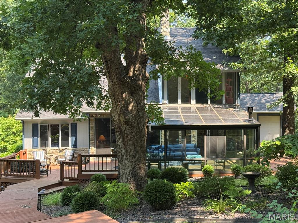 Come home across a charming stone bridge, up a winding drive, through beautifully landscaped, park-like grounds in a secluded setting.  Enjoy a truly impressive, uniquely designed 4-bedroom, 3.5 bath home that catches the eye as you pull up into the expansive paved parking area dappled with sunlight through the trees. You're greeted with a dramatic two-story, beautifully-lit foyer, unusual balcony walkway connecting upper level beds/baths, and vaulted ceilings highlighted by a floor-to-ceiling stone fireplace. The very spacious four-seasons room, crowned with a ceiling of windows creates the feel of the outdoors while keeping you warm in the winter and cool in the summer! Breathtaking views from this home in every season! Extensive composite decking with three separate outdoor living areas including a large gazebo with firepit — perfect for entertaining or simply taking in the peaceful surroundings.
Oversized 3-car garage offers ample storage, while the full basement provides even more living space with a recreation area, wrap-around bar, and convenient walk-out/up access. 
With too many features to list, this home is truly one of a kind. Whether you’re hosting gatherings or seeking solitude, it delivers privacy, luxury, and comfort in every detail.
Set on 5 acres surrounded by woods and wildlife - calling your name! Have your verified pre-approval in hand... call for your private showing today!