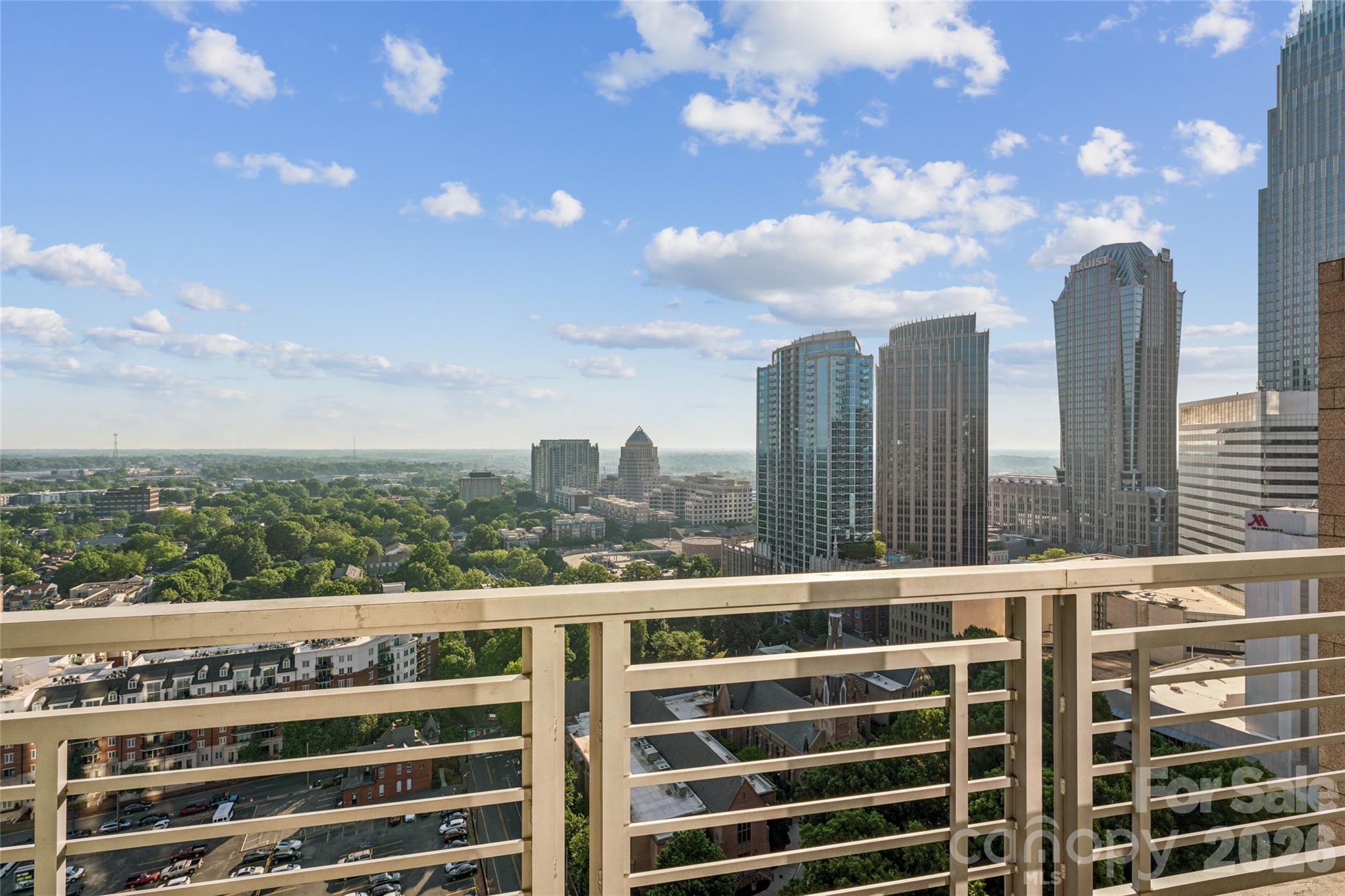 Get ready to be impressed! This stunning corner unit on the 22nd floor at Trademark offers a rare high floor opportunity to own a luxury residence with sweeping sunrise views over Uptown Charlotte. Enjoy your private balcony as the city comes to life each morning. The spacious open floor plan is filled with natural light! Gorgeous floor-to-ceiling windows, showcasing panoramic skyline views that stretch for miles. Both bedrooms feature darkening shades, providing the perfect balance of brightness and privacy. Brand new laminate wood flooring installed in 2025 adds a fresh, modern touch, complementing the unit’s clean lines and elevated feel. Every detail reflects modern elegance and effortless sophistication. This move-in ready condo includes two deeded parking spaces and has been meticulously maintained and updated, including fresh interior paint, a new HVAC system and water heater in 2023, a newer washer and dryer from 2021, and a dishwasher replaced in 2023. Located in the heart of Uptown, you are just steps from Bank of America Stadium, Spectrum Center, and Truist Field, along with top dining, shopping, and entertainment right downstairs and around you. Residents enjoy premier amenities including a community pool, outdoor grilling area, indoor hangout area, fitness center, and dog park, all designed to complement an elevated urban lifestyle. Furniture negotiable!