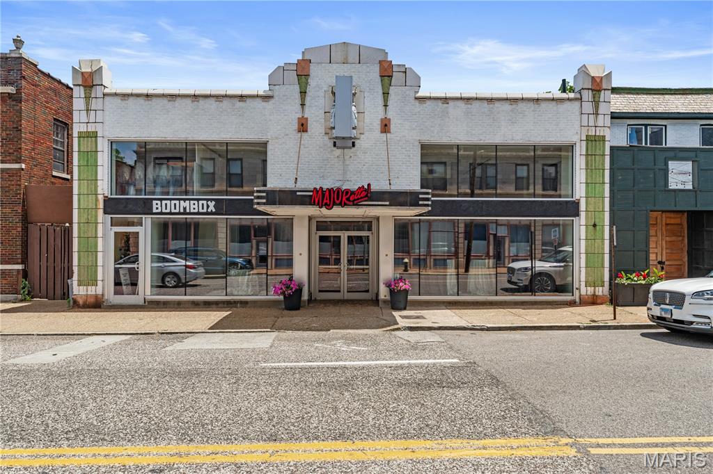 A truly iconic venue, The Majorette blends historic character with endless potential. Originally a neighborhood furniture store, the building has been transformed into a vibrant event space with seamless indoor-outdoor flow. The main level features a dramatic open room with a large bar and a wraparound mezzanine balcony—perfect for watching the energy of a party from above. A charming courtyard leads to a second structure that has been demoed inside and is ready for your custom vision. Out back, a spacious deck provides even more space to gather. Downstairs, the lower level offers additional income potential with a second bar, pool tables, a caterer's kitchen, a bathroom, and storage space. It's currently used for weekly events, offering steady cash flow. The sale includes a generous portion of the large parking lot behind the building, which is rare for the area. Continue operating The Majorette as a wedding and event venue, or reimagine it as a restaurant, retail space, or creative concept. A standout opportunity in one of St. Louis' most walkable and energetic neighborhoods.