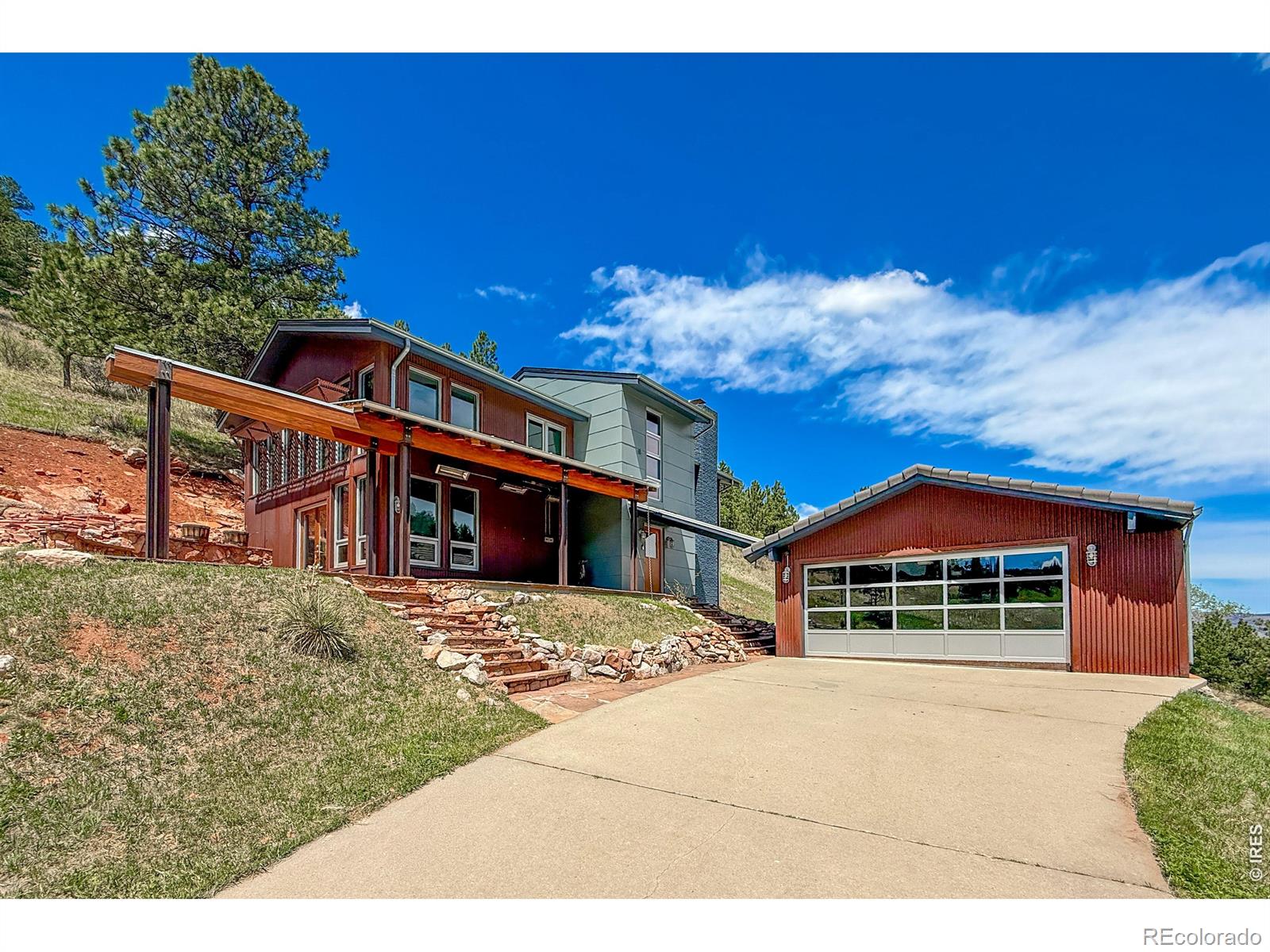 Featured in Colorado Homes & Lifestyles magazine after complete remodel in '09, this architectural marvel offers a rare blend of rugged mountain aesthetics and refined modern luxury. Step inside this 3/2 loft home--the ultimate entertainer's sanctuary, boasting sweeping unobstructed views of Olde Stage Canyon. Commercial aluminum windows soar throughout flooding the space with natural light. Anchoring the space is a striking metal encased fireplace that extends the height of the home. Every detail has been curated for the consummate host. The home is pre-wired for B&O sound system, features a wine cellar, sunroom, patio and porch(heated) for year round entertaining. Multiple lofts fill the vertical space. The layout flows seamlessly across natural slate floors on the main level to warm wood floors upstairs. The baths boast slate, concrete & steel incl cool light fixtures complete with Hansgrohe Axor Starck faucets/fixtures creating a spa like experience. Striking design features also include exposed architectural steel, a massive glulam beam, tension cable railings, spiral staircase and rusted corrugated metal siding. The drive thru garage features a striking commercial aluminum framed glass garage door. Enjoy peace of mind knowing there is an AHS Plus Home Warranty offered by the seller, new shingle roof(warranty/inspected) and new septic tank(inspected). 6709 Olde Stage Road is more than a home; its a living piece of art designed for those who love to celebrate in style!