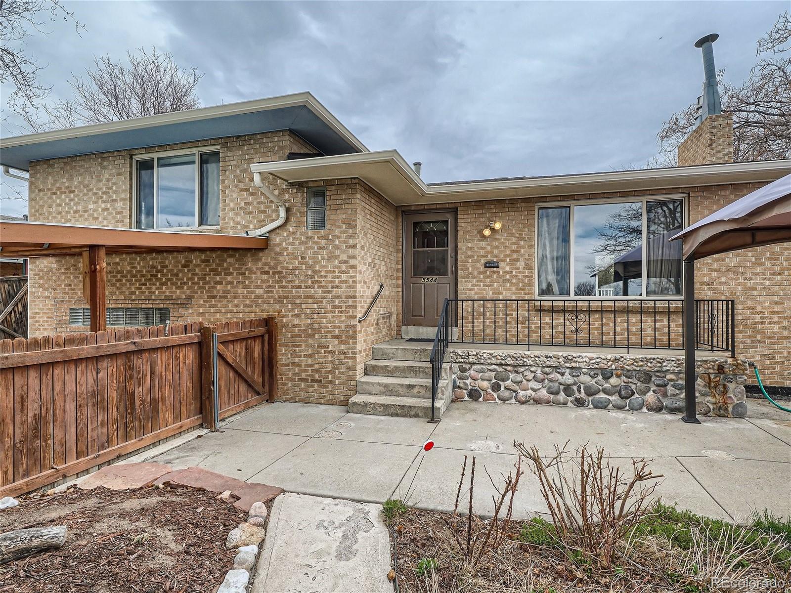Welcome to this spacious 3 bedroom, 2 bath home that exudes charm and style. From the moment you step inside, you will be greeted by the warm and inviting living areas, perfect for creating memories with loved ones. The updated kitchen is a chef's dream, featuring stainless steel appliances, new cabinets, and a solid surface countertop that adds a touch of elegance to the space.  All appliances are included, so you can start enjoying this beautiful home right away. The wood floor complements the kitchen's warm and cozy feel, while the new carpet brings a sense of comfort to the bedrooms.This home also boasts a huge flex space that can be used as a workshop, playroom, or whatever your heart desires, or convert it back to a garage.  As you step outside onto the deck, you will find yourself in a huge yard with amazing landscaping, a garden area and storage shed. The yard is fully fenced, providing privacy and a place to relax under the included gazebo.  This home comes equipped with central AC, making it the perfect oasis on those hot summer days. Its great location also provides easy access to all the amenities you need, with a park Acrossed the street.  Multiple living rooms or flex spaces to make this home truly unique for all living situations and provides multiple “work at home” options.  Overall, this home is the perfect blend of style, comfort, and convenience, making it a must-see for anyone looking for their dream home.