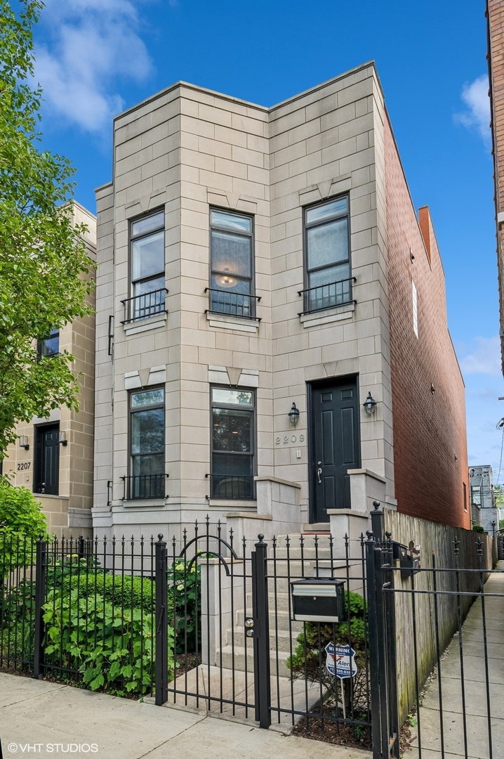 Located in the heart of West Town, this all-masonry single-family meticulously maintained home offers space, style, and four incredible outdoor areas-including a south-facing rooftop deck with stunning skyline views. Step into the spacious living room with bay window and fireplace, flowing into the dramatic dining space with soaring two-story ceiling. The spacious kitchen is perfect for cooking and entertaining, featuring granite countertops, 42-inch cabinetry, stainless steel appliances, an island with seating, and excellent prep and storage space. It opens to the family room, which leads out to a new deck ideal for grilling and a beautifully landscaped paver patio. Upstairs, the large primary suite boasts its own private deck, professionally organized walk-in closet, and spa-like bath with dual vanity, soaking tub, and separate shower. Two additional bedrooms, full bath, and laundry complete the second level. Interior stairs take you to the rooftop oasis with breathtaking city views. The lower level offers a large rec room, oversized bedroom, full bath, 2nd laundry room and abundant, custom-organized storage. A 2-car garage completes the package. Walk to restaurants, grocery stores, and transportation-this one has it all.