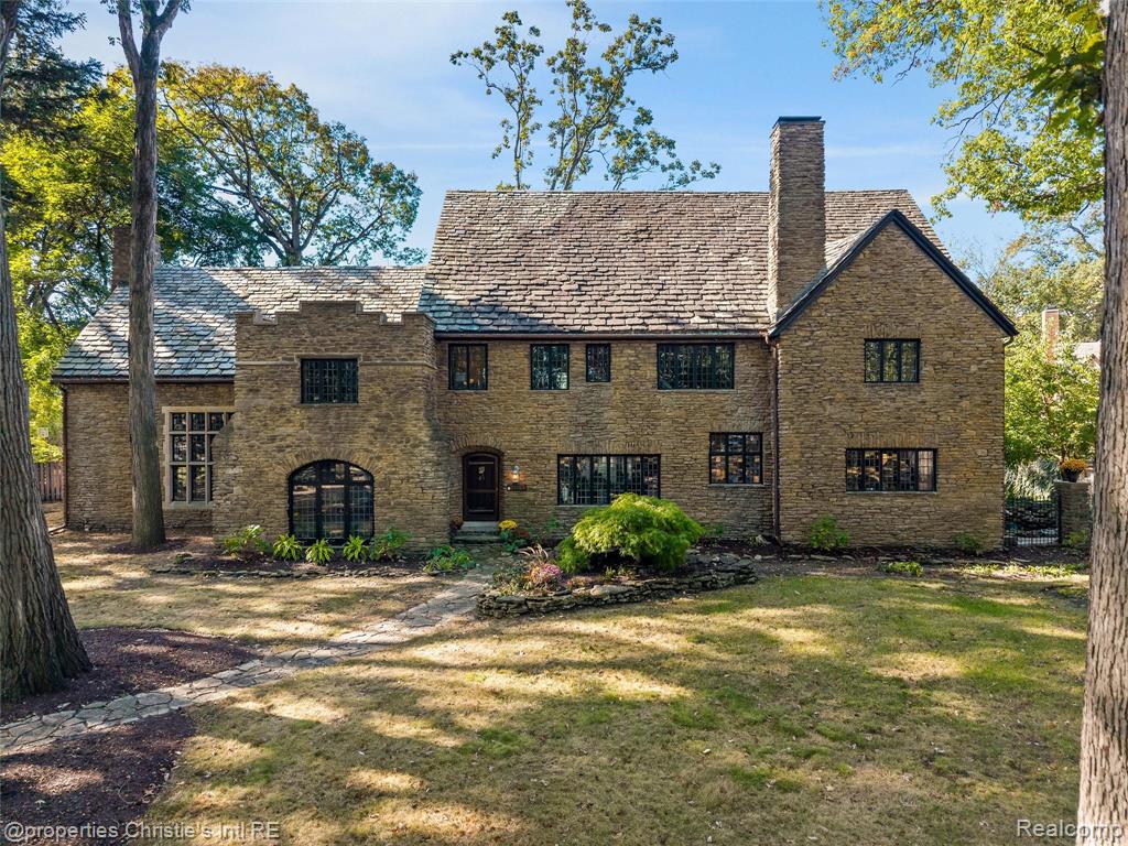Step into timeless grandeur at 19551 Burlington Drive—one of Palmer Woods’ most distinguished architectural masterpieces.

Designed in 1925 by acclaimed architect Leonard Willeke, this 8,371-square-foot Tudor Revival residence is a triumph of craftsmanship and preservation. Every detail has been meticulously restored to honor its 1920s heritage while integrating modern comfort.

The exterior, constructed of rare Kentucky schist stone, was inspired by England’s Cotswold cottages. A slate roof, leaded-glass windows, and refined detailing set the tone for what awaits inside—a breathtaking 1,000-square-foot great room with cathedral ceilings, hand-hewn beams, elevated walkways, and walls of arched glass. Nearly every original feature has been preserved or recreated with precision, from Michigan white-oak paneling and German-silver hardware to Flint Faience tile and ornate plasterwork that showcase the artistry of the era.

The kitchen blends historic charm with modern function, featuring refinished cabinetry, new appliances, and custom White Oak floors. A built-in, original Chrysler-Koppin refrigerator—fully restored and operational—remains a remarkable piece of Detroit innovation. The reimagined primary suite offers a spa-inspired bath, dressing room, and sitting area that captures natural light and warmth.

Every major system has been thoughtfully renewed, including new plumbing, extensive electrical updates, and a discreet high-velocity central A/C system serving all three floors. Restored radiators, refinished hardwoods, and restored windows with added interior storms for energy efficiency complete the home’s transformation.

Set on landscaped grounds shaded by mature trees, the property includes a stone patio with a fountain—a tranquil outdoor retreat. Just steps from the Detroit Golf Club and in close proximity to downtown Detroit, Ferndale, and Birmingham, this residence embodies the artistry, history, and enduring beauty that define Palmer Woods.