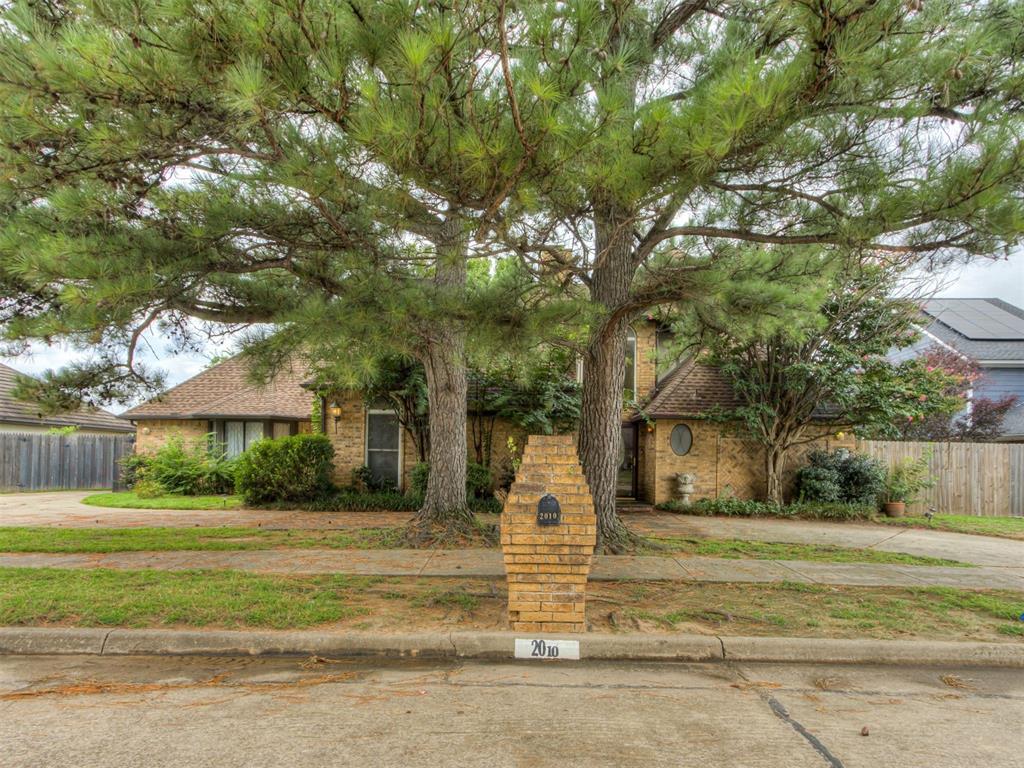 Welcome to this amazing home in the  Rock Creek Polo Club neighborhood! This 4 bed, 2 and a half bath traditional-style house offers a comfortable and inviting atmosphere. The spacious living room features a full wet bar, making it a great spot for entertaining. Beautiful atrium doors open up into a sun porch, allowing natural light to fill the space. A central stairway leads to a suspended balcony that overlooks the living area, while a cozy fireplace adds warmth to the ambiance. The large master bedroom comes with an en suite bathroom, providing convenience and privacy. The secondary bedrooms are great sizes and flexible to your needs. The kitchen has plenty of counter and cabinet space for all your cooking needs, and you’ll enjoy lovely views of the horse farms to the west. While the garage has been converted into a bright space with a bay window, it could easily be reverted back for parking if desired. Plus, a storm shelter in the garage area adds an extra layer of safety. This home is a wonderful opportunity in Rock Creek Polo Club—schedule your showing today!