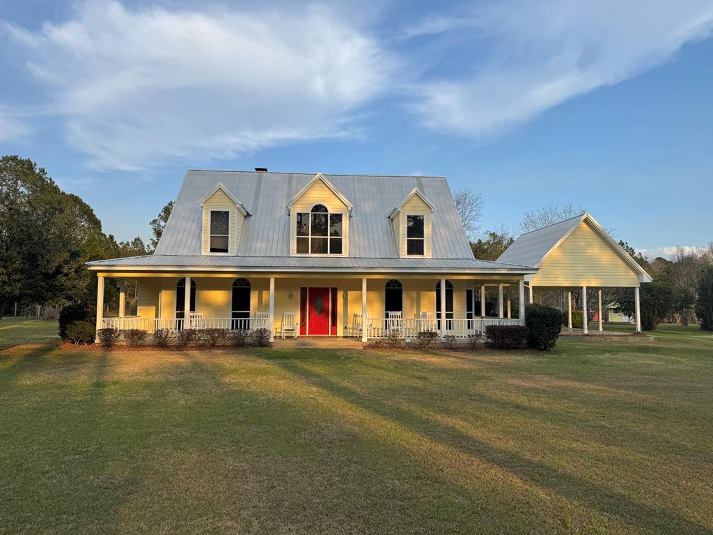 Discover the perfect combination of luxury, comfort, and versatility with this exceptional property set on 48 beautiful acres. This home features 3 bedrooms, 2 full bathrooms, and 1 half bathroom, along with a resort style pool.   At the center of the home is a spacious kitchen that opens to the living room, creating an inviting area ideal for entertaining and everyday living. The kitchen is thoughtfully designed with custom wood cabinetry, quartz countertops, a custom backsplash, a gas cooktop and double ovens.  The primary suite has plenty of windows to take in the scenic views.  It offers a peaceful retreat with a fireplace and private porch that overlooks the resort style pool.  The 48 acres provide endless possibilities. Planted pines and pecan trees create a beautiful entrance to your property.  The wooded areas are perfect for deer and turkey hunting. You will also find an abundance of fruit trees and muscadine grapevines.  The property is already fenced and cross-fenced.  This offers an ideal setup for livestock and a chicken coop is already in place.  Additional improvements include four workshops, two wells, a playhouse and playground for the kids.   You will feel like you are on vacation every day with the resort style pool. When you are done swimming, relax in the built-in hot tub under the palm trees.  This is what you need to enjoy quiet evenings or host friends and family. Don't miss this rare opportunity to own this one-of-a-kind property.