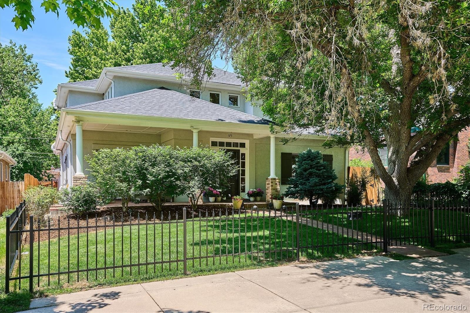 Exceptional East Washington Park home with 4BR/4BA, main-level study, finished basement and rare spacious mudroom with attached two-car garage on true double lot. Thoughtful layout, timeless finishes and prime location, just three blocks to Wash Park and near Old South Gaylord shops and dining. Gourmet kitchen, wonderful updated primary suite with fireplace and walk in closet , professionally finished basement, wood flooring throughout, fresh interior  paint, and new back yard with sod and large deck, to name a few. A gorgeous fenced yard, complete with mature trees, perennials and spacious back patio, is excellent for entertaining in front and back. Upon entering, the open, two-story foyer dazzles with loads of natural light. In the heart of the home, you find the expansive kitchen with Quartz countertops, custom cabinetry, stainless Viking appliances, wine refrigerator and pantry area. The kitchen also features a huge island with eat-at bar and breakfast nook, and it opens to the inviting great room with gas fireplace & the tranquil back deck and lovely yard. Completing the main level are the formal dining room, powder bath and flex space off the great room, which descends a few steps into the mud room area with garage access. On the second floor, the expansive primary suite beckons with its vaulted ceilings, gas fireplace with tile surround, five-piece spa-like bath and generous walk-in closet. Also on the second floor are two additional bedrooms each with vaulted ceilings, a full bathroom with windows opening to skylights and a large linen closet. The professionally finished basement, with brand new wet bar, also has a spacious family room, guest bedroom, updated bathroom, 450-bottle wine cellar, laundry and mechanical rooms, and additional storage. Truly one of the best locations in all of East Washington Park. This one checks all the boxes!