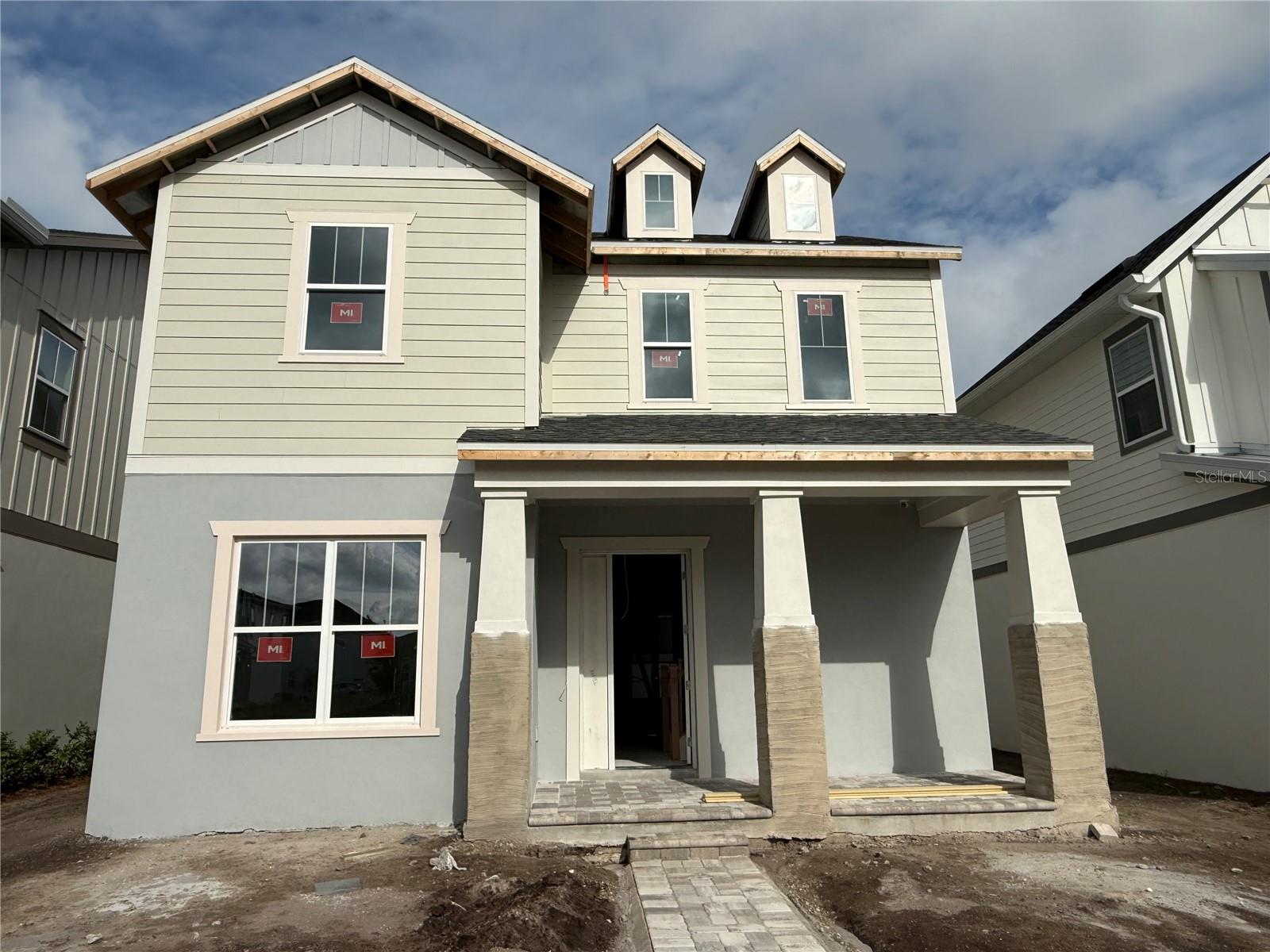 Under Construction. Perfectly positioned overlooking one of Laureate Park's picturesque parks and mews, this beautifully designed Bermuda floorplan offers the rare combination of timeless architecture, flexible living spaces, and the craftsmanship of a true custom home builder. More than just a home, this is an opportunity to enjoy a lifestyle centered around community, connection, and personalization. Inside, the open-concept design creates an inviting flow between the kitchen, dining, and living areas, making everyday living and entertaining effortless. The gourmet kitchen features an oversized island, abundant cabinetry, and generous storage, creating a natural gathering space for family and friends. Large windows lead to the covered lanai, extending the living space outdoors and embracing Florida's indoor-outdoor lifestyle. A versatile flex room on the first floor offers endless possibilities, whether you envision a private home office, library, fitness room, or guest retreat. Upstairs, the spacious owner's suite provides a relaxing sanctuary complete with a luxurious bath, dual vanities, walk-in shower, and oversized closet. An open loft creates additional living space perfect for movie nights, a playroom, or a secondary lounge area, while two additional bedrooms provide comfort and privacy for family and guests. Adding exceptional flexibility and value is the private apartment above the garage, complete with its own entrance, bathroom, kitchen, and laundry. Whether used for visiting family, multi-generational living, a private workspace, or rental income opportunities, this versatile space offers countless possibilities. Built by one of Florida's premier custom home builders, this residence reflects a commitment to quality, craftsmanship, and personalization. Unlike traditional production builders, homeowners have the ability to tailor spaces to fit their unique lifestyle, creating a home that feels truly their own. Beyond the front porch, enjoy the award-winning Laureate Park lifestyle with resort-style pools, a state-of-the-art fitness center, tennis and pickleball courts, miles of walking and biking trails, community events, neighborhood dining, and high-speed fiber internet included in the HOA. Located minutes from Medical City, Orlando International Airport, and the best of Lake Nona, this home offers the perfect blend of luxury, flexibility, and vibrant community living.