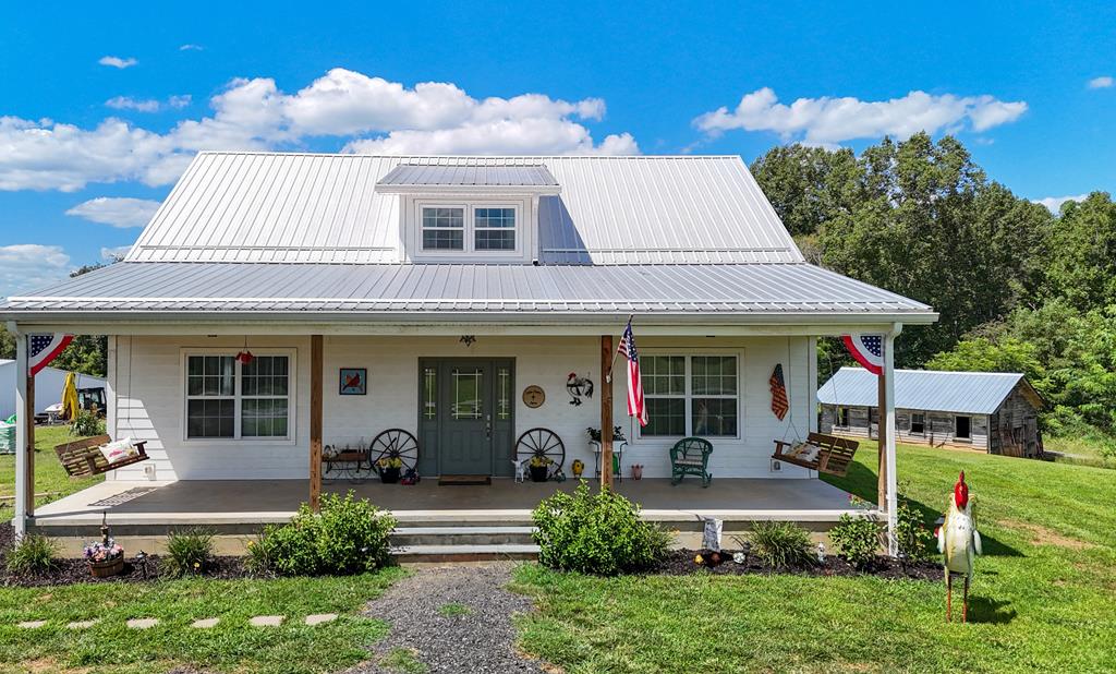 Completely remodeled two-story home situated on 2.21 acres with frontage on a state-maintained paved road in the countryside of Patrick County. Extensively renovated between 2021 and 2023, this home was rebuilt down to the studs with numerous structural and modern upgrades. Ceilings were raised, and the roof was lifted to create additional height and living space on the second floor. The exterior features low-maintenance composite siding, and two separate heat pumps provide efficient climate control for each level.  The main level offers a foyer, spacious living room, beautifully kitchen with center island, dining area, half bath, laundry room, bonus room with exterior access, and a Master bedroom and Master bath. Upstairs, you'll find a family room area, two additional bedrooms and a full bathroom, providing space for family and guests.  Front porch (40' x 10') where you can enjoy morning coffee, read a book or just enjoy country life.   The original home located just behind the main residence (14' x 20'), this structure served as the sellers' living quarters while the main home was under construction. It features an open-concept living area with kitchen, bedroom, and bathroom, making it ideal for a guest house, home office, or hobby space. Wooden storage building with metal roof.  Conveniently located just 10 minutes from Stuart, VA. 30 minutes from Martinsville, VA.  30 minutes to Mt. Airy, NC. A new hospital opened in Stuart, VA - January 2026.