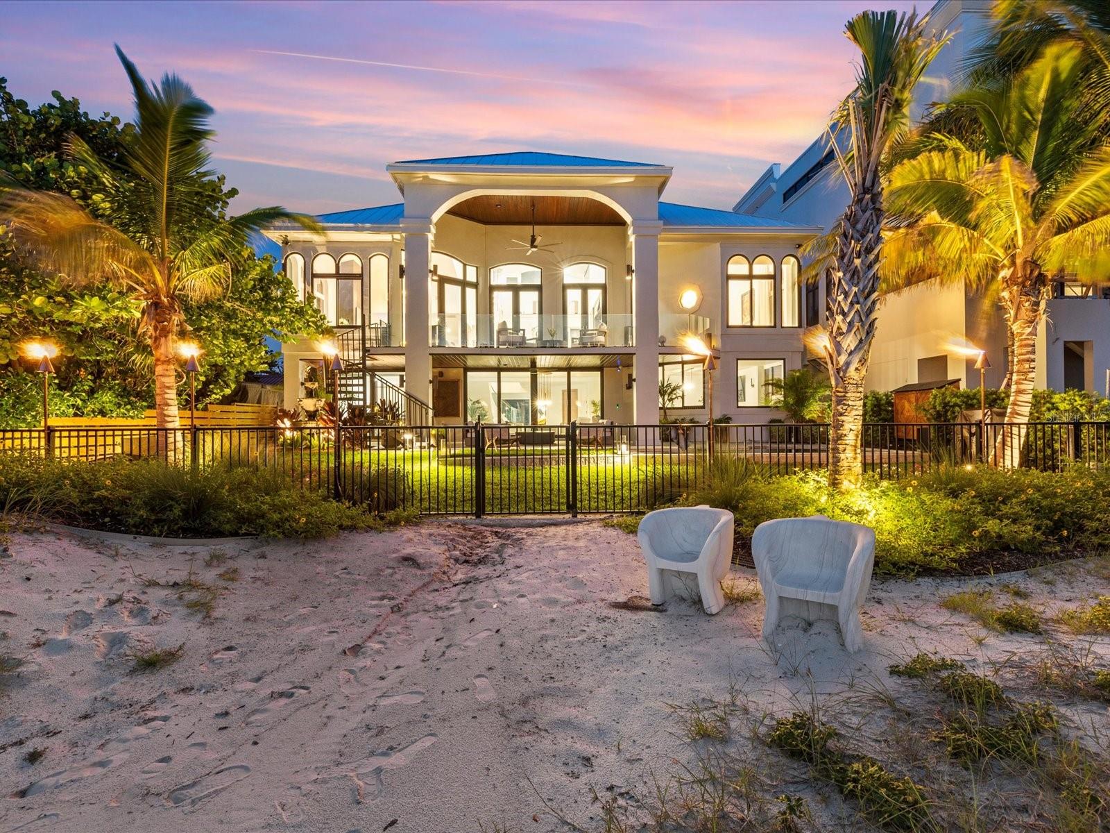 EXCEPTIONAL BEACHFRONT LIVING | 60 FEET OF DIRECT GULF FRONTAGE | EXTENSIVELY RENOVATED

Welcome to your private slice of paradise on Clearwater Beach — a move-in ready, fully renovated 5-bedroom, 5-bathroom coastal retreat offering breathtaking views, unforgettable sunsets, and the kind of beachfront lifestyle that brings families together for generations.

From morning walks along the sand to holiday dinners with your feet in the surf, this home offers more than luxury — it’s a destination for connection. With 60 feet of direct Gulf frontage and expansive views from both levels, you’ll enjoy unobstructed vistas of the water from nearly every room.

Inside, the open-concept layout is ideal for gathering — featuring a designer kitchen with marble countertops, high-end appliances, and a spacious dining and living area anchored by a dramatic water vapor fireplace. With 10+ TVs, a billiards room, and a dedicated office, every space has been curated for both comfort and entertainment.

Whether it’s morning walks along the shoreline, sun-soaked afternoons by the pool, or evenings spent exploring Clearwater’s vibrant dining scene, this home offers the full Florida lifestyle — relaxed, refined, and made for memories.

Step outside to your private backyard oasis — complete with a heated spool (spa/pool combo), built-in fire pit, lush tropical landscaping, and elegant gas lantern lighting. Whether you’re sipping cocktails at sunset, toasting marshmallows under the stars, or watching your kids play in the sand just beyond your gate, this home is made for making memories.

Additional highlights include:
 • 2-story floor plan with Gulf views from both levels
 • 10+ TVs included 
 • Spool with hot tub & gas heater
 • Fire pit for evening relaxation
 • Deeded boat slip & furnishings negotiable
 • Professionally landscaped grounds with multiple outdoor living spaces

Important Note: This home sustained no interior water damage from recent storms.

Beachfront homes of this quality — especially those turnkey, tastefully renovated, and designed for multigenerational living — are rarely available in Clearwater Beach. Schedule your private showing today and envision the holidays, sunsets, and lasting memories that await.