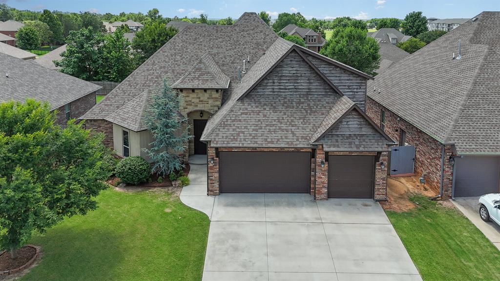 Your dream home awaits you, on the cusp of the vibrant college and tech scenes, yet close enough to accomplish all of your errands and store runs with time to spare! Commutes are nothing compared to city life elsewhere with campus drop offs in 15'ish minutes, major shopping and eateries are 2-20 minutes in all directions, museums in 10 minutes, Lake Thunderbird in 15 minutes and a National Weather Center in a few minutes! A stunning residence such as this offers a versatile layout for all! With a welcoming study or 4th bedroom of the entry, this room features a walk-in closet and a uniquely stylish and stained wood accent wall. Enjoy some open concept living bathed in natural light, highlighted by a stone accented fireplace with mantle, wood look floors flowing into dining and kitchen areas. Kitchen boasts updated stainless cooking, 5 burner gas cooktop, cabinets for days, breakfast bar area, granite, and a walk-in pantry! Dining area is ideal for entertaining or enjoying a relaxing night! Wall enclaves greet you on your way to this primary suite! A barreled vault ceiling with wood accents delights you, a patio retreat soothes you, and multiple layout and sitting area options creates a feeling of luxury! En suite includes dual vanities, framed mirror, powder space, exquisite brushed nickel fixtures, elegant soaker tub, and a true walk-around shower! Pass through a generous walk-in closet to access your laundry area! No more excuses! Additional guest beds include ceiling fans and the secondary bath is also blessed with two vanities and shower-tub! The 5th bed, bonus, or game room is situated upstairs with a mini-split, walk-in closet, and full bath! Ample patio space and an incredible built-in grill complete your outdoor living! This home is perfect for relaxation and entertaining, along with a true 3-car garage! Don’t miss out on this once in a lifetime opportunity! Take advantage of the video and 3D tours before your private viewing! This dream home is yours!