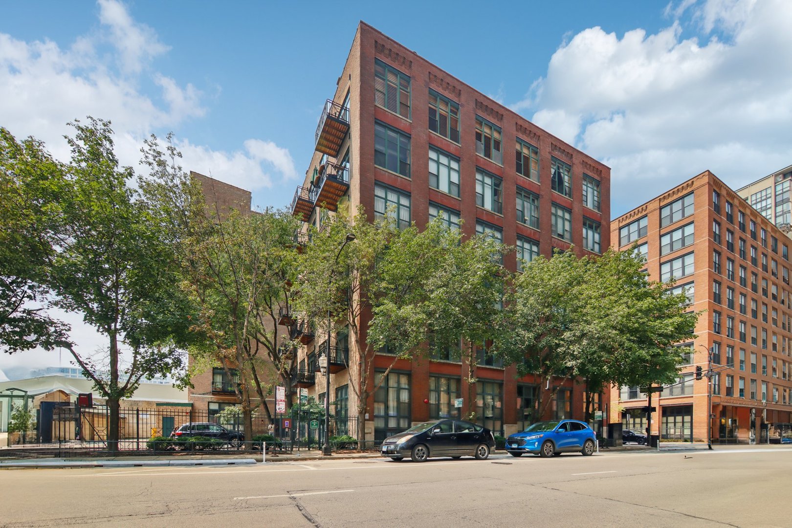 Live the Loft Life in the Heart of the West Loop! Step into this stunning boutique timber loft and experience the perfect blend of character and comfort. This spacious 2-bedroom, 1-bath home boasts soaring 12' timber ceilings, exposed brick walls, rich hardwood floors, and oversized windows that flood the space with natural light. The beautifully updated kitchen is a chef's dream, featuring granite countertops, KitchenAid stainless steel appliances-including a double oven-and plenty of space to entertain. Enjoy cozy nights by the gas fireplace, morning coffee on your private balcony, and the convenience of side-by-side in-unit laundry. You'll love the two walk-in closets with custom organizers and generous in-unit storage. Common rooftop deck is the perfect spot to enjoy great city views! Located just seconds from everything you love-Fulton Market, the Loop, Greek Town, Mariano's, Whole Foods, D'Angelo Dog Park, Divvy Bikes, Starbucks, and the UIC Blue Line CTA stop. Garage parking included in the price and investors welcomed!