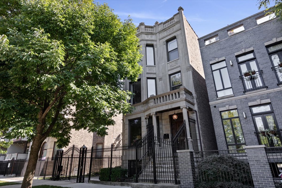 Fantastic opportunity to purchase a literal campus directly overlooking Humboldt Park. This graystone was converted into a stunning, and massive, single family home. The structure was meticulously rehabbed and features fantastic quality and custom vintage inspired details throughout. Huge rooms with large bay windows, 4 separate living spaces, 5 bedrooms and 4.1 bathrooms with abundant storage. The facade is stunning, with ornate limestone details and huge windows looking into 200 acre Humboldt park. Great finish details, like quarter sawn oak floors, hard wood window sills and casings, soaring ceiling heights, and solid core doors with custom hardware.  3 wood burning fireplaces, including one in the stunning primary suite. Next to the main residence is a wide side driveway. Reclaimed granite pavers from historic Maxwell Street create a stunning backdrop as you drive through the gated entry. There is comfortably room for 3+ cars, and one could build a carport or garage if they desired. At the back of the lot sits a 2 unit coach-house. This gorgeous red brick structure features 2 one-bedroom apartments and a full basement for storage. The apartments were recently rehabbed and have new kitchens and bathrooms, laundry and full HVAC. These provide great income. The Hi/Lo, Spinning J's, California Clipper, and lots of shopping is all right around the corner. Recently added bike lanes in front of the building reflect the city's ongoing commitment to creating a super pedestrian friendly park. Must see!