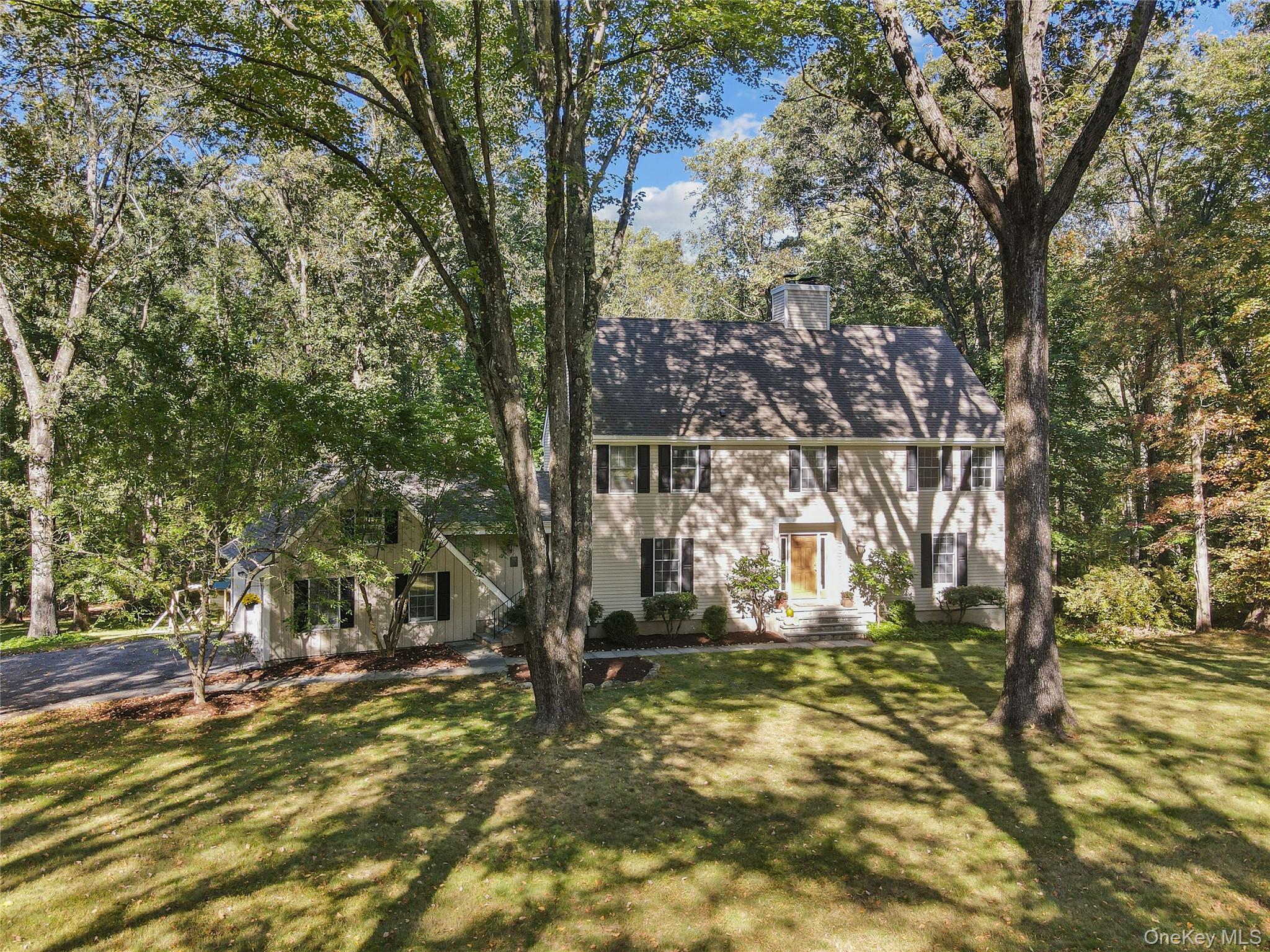 A rare combination of beauty, space, and tranquility in an exceptional Bedford Village location. This home balances country charm with everyday convenience, offering bright and inviting interiors with a timeless, traditional floor plan. The spacious kitchen, flows seamlessly to family room/fireplace with access to an expansive deck—perfect for indoor-outdoor living. The serene 1.5 acre property is bordered by 12 acres of open green space. Formal dining and living rooms, additionally a main level office provides a quiet work or study space. Primary Bedroom and Bath (2021)  with radiant heated flooring, soaking tub, shower. Three bedrooms, updated modern hall bath. Walkout lower level with full bath, completely flexible space, media, exercise, recreation, playroom. Freshly painted, hardwood flooring throughout, attached two car garage. 3.8 miles to Bedford Village and Bedford Village Elementary school. 7.8 miles to Bedford Hills Metro North station. A special place where comfort meets convenience.