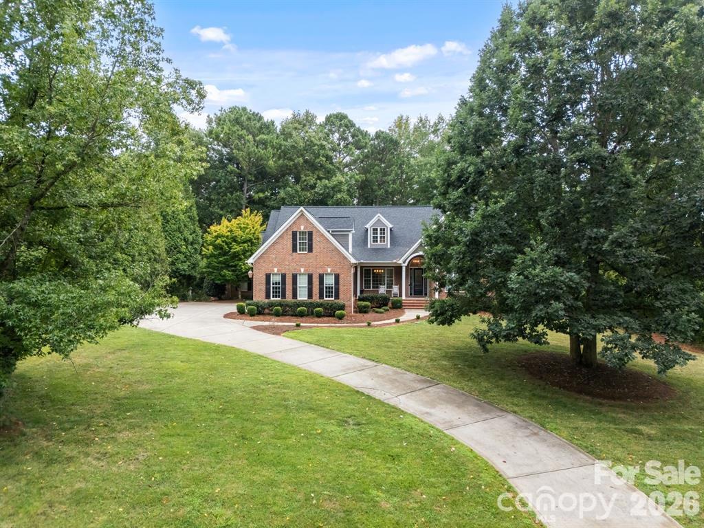 Welcome to an exceptional waterfront retreat in one of Belmont’s most prestigious gated communities, where refined living meets the beauty of nature. This property does back up to a cove, however, it is a small cove that is not always usable, but has the ability to launch a kayak from your own backyard water level permitting, or enjoy neighborhood marina access with a private boat slip and lift on Lake Wylie. Designed for both relaxation and entertaining, the outdoor spaces are truly remarkable , featuring a spacious covered deck made with Trek composite, built-in hot tub, firepit, and an expansive, private backyard that feels like your own secluded sanctuary. A breathtaking sunroom serves as the heart of the home, showcasing soaring ceilings, walls of windows, and sweeping views of the peaceful backyard. Filled with natural light, this stunning space offers the perfect setting for quiet mornings, elegant gatherings, or simply enjoying the beauty of every season.Inside, timeless architectural details and rich hardwood floors create an atmosphere of warmth and sophistication. A welcoming foyer opens to a formal dining room ideal for hosting, while the beautifully appointed kitchen features custom cabinetry, a bright breakfast area, and an inviting hearth room. The main-level primary suite offers comfort and privacy, complemented by a dedicated office for work or study. Upstairs, a huge bonus/bedroom with full bath and walk in closet. An amazing private media room, exercise room, a study for homework and ample storage including a walk in attic. So many upgrades, including Irrigation system, Bluetooth/radio/HDMI hookup speaker system through home. and zoned HVAC system! Endless possibilities for recreation, guests, or hobbies.Ideally located just minutes from charming local shops and dining and the renowned Daniel Stowe Botanical Garden, with convenient highway access for an easy commute. This is more than a home ,it’s a lifestyle defined by elegance, comfort, and effortless lakeside living.