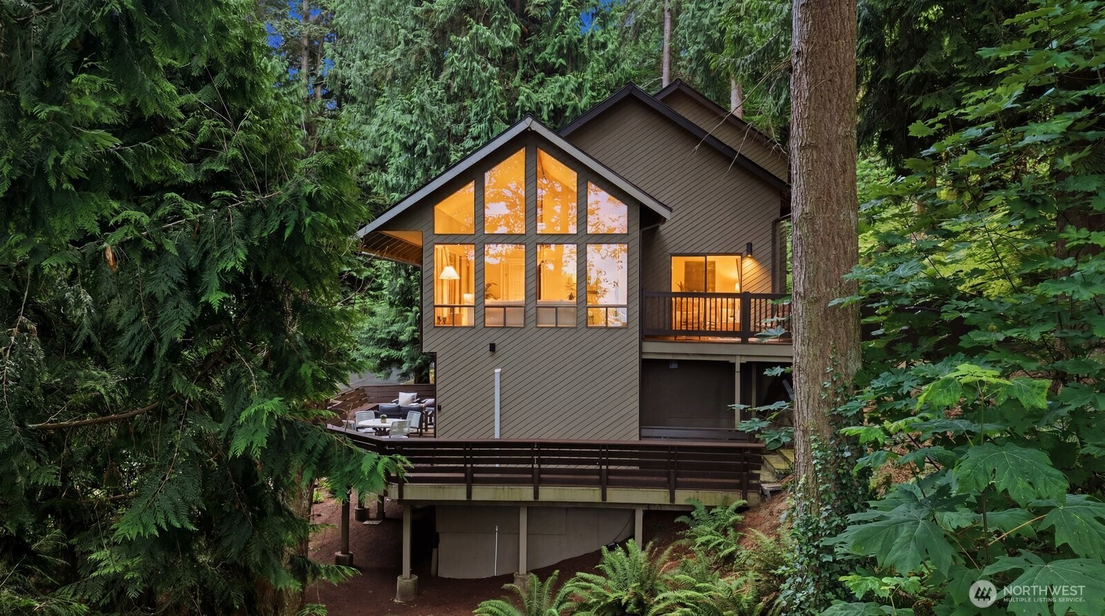 Thoughtfully updated home tucked into the trees in sought-after Meadowdale Beach in Edmonds, featuring a beautifully designed income-producing lower-level ADU. Surrounded by a private, forest-like setting, this sophisticated retreat blends modern luxury with the tranquility of Pacific Northwest living. The renovated main and lower-level kitchens showcase timeless shaker cabinetry, quartz countertops, and elevated fixtures throughout. Vaulted ceilings and expansive windows fill the living room with natural light while framing partial views of the Puget Sound and beautiful evergreens, creating the feeling of a refined treehouse sanctuary. Quiet, serene, and moments from the beach and nearby parks, the home offers an effortless connection to nature without sacrificing comfort or style, including multiple decks to enjoy the outdoors. Two luxurious primary suites feature adjoining spa-inspired bathrooms with designer tile work, curated finishes, and calming modern palettes. With a spacious and versatile layout, including main floor den/office, the property offers endless possibilities for multigenerational living, guest accommodations, or investment potential. The separate lower-level entrance and dedicated parking allow the permitted ADU to function as a fully independent residence, making it an exceptional opportunity in one of Edmonds’ most desirable neighborhoods. Located within highly rated school boundaries.