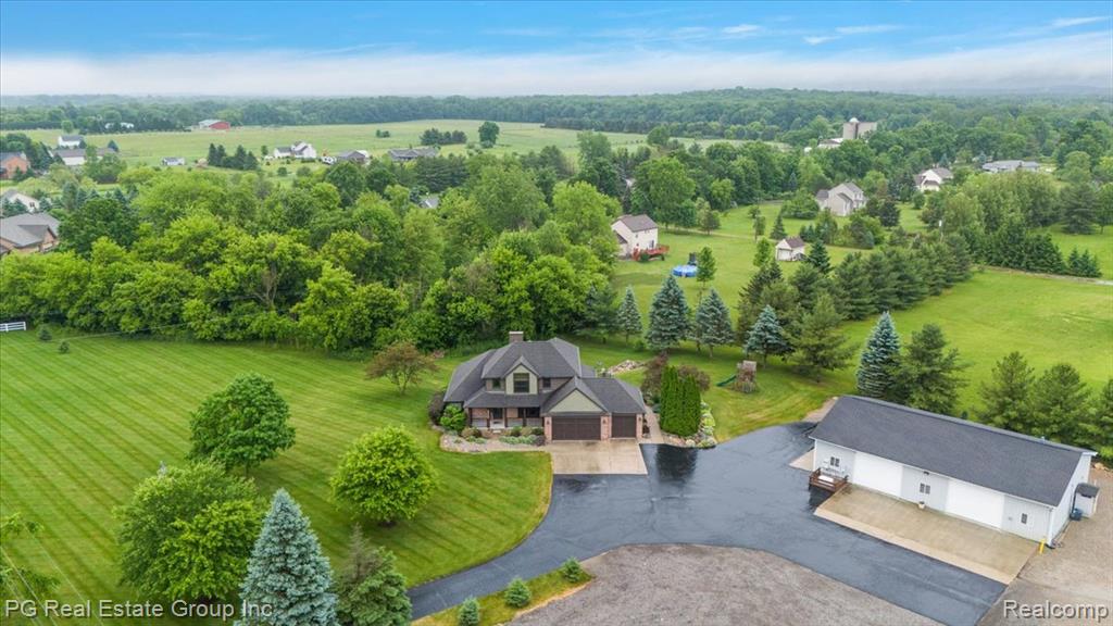 Tranquil retreat nestled on a picturesque 5 acre parcel.  Meticulously maintained custom-built 4-bedroom, 3.5-bathroom home with finished walkout basement. Over 4,000 sqft of living space! Upon entry you are greeted by a two story foyer. The spacious living area features a stone fireplace and pine ceilings. The kitchen is a chef's delight, boasting stainless steel appliances, including Viking gas stove, hood, and Sub-Zero Refrigerator, ensuring both style and peace of mind. Beautiful cabinets, granite countertops, and a large island. A massive first floor primary suite features a remodeled bath with walk-in tiled shower and a large walk-in closet. Convenient first floor laundry. Second floor features 3 spacious bedrooms and a full bath. Paved road making your oasis conveniently accessible to shopping and entertainment. Direct access 3 car garage plus a large pole barn 40x64 with cement floor, electric, air compressor, hoses, 3 hydrants, insulated with heater, and an extra room that can be used for an office space.
Finished walkout basement is an entertainers dream featuring a mother-in-law suite with full kitchen/bar, full bath, laundry room, living room, dining room, bonus room, and a fruit/storm cellar.
This exceptional home is equipped with a whole house generator giving you peace of mind. Step outside on the Trex deck to enjoy the serene surroundings. Wildlife enthusiasts will appreciate the abundant wildlife that frequents the property, creating a nature lovers paradise.
New windows, siding, garage doors w/openers, and deck in 2019.  Furnace, air conditioner, hot water heaters, and water softener are new within the past 4-6 years. Whether you're seeking solace in nature or entertaining guests in style, this home has it all for your lifestyle aspirations!
Don’t miss your chance to own this remarkable retreat!
