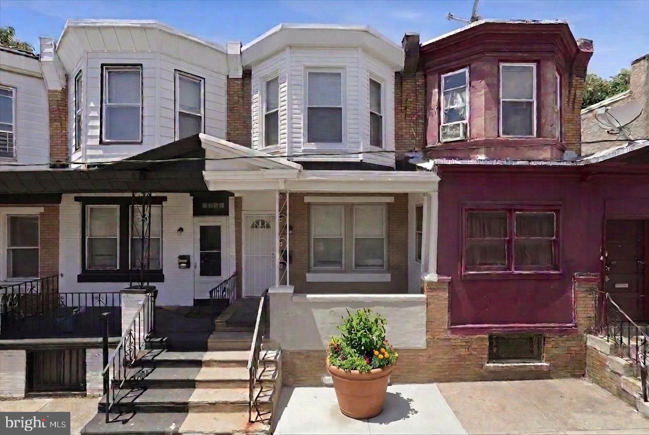 **NEWLY RENOVATED HOME READY TO MOVE RIGHT IN**Step up to your freshly painted classic Philly front porch. It is ready and waiting for your chairs, plants and creating curb appeal. Once inside you will notice all the updates that make this home feel fresh and new. The first floor features an open living/dining concept with new luxury vinyl flooring in a soothing color palate. There is no shortage of space for all your furnishings and whatever custom layout you envision. Beyond the dining room is the kitchen that utilizes all the space in a very functional way. It is fitted with new crisp white cabinetry, new granite countertops spanning both sides and a new stainless steel double oven with range hood. From the kitchen, step outside to a cozy paved patio with new wood fencing offering privacy and a place to relax and grill. The 2nd floor features plush new carpeting, 2 large bedrooms, bright windows and a full half bath with new vanity, mirror, toilet and shower/tub combo. This home is rounded out with a clean, painted basement with washer/dryer hookup, new heater, new hot water tank and plenty of storage area. As a bonus this home features a new roof, new siding and all new windows and doors. For price, location and condition this one can't be beat. Schedule your showing today or call for a private tour.