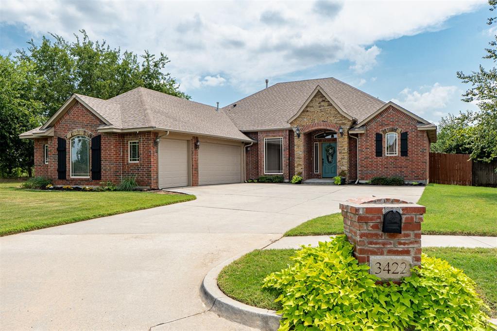 Tucked away at the back of a quiet neighborhood, this exquisite 3-bedroom, 2-bath home with a 3-car garage offers style, comfort, and thoughtful design throughout. A curve-around driveway provides ample parking for several vehicles. Inside, the warm wood kitchen is highlighted by black granite countertops, a gas range, stainless steel appliances, a spacious walk-in pantry, and a long, curved breakfast bar that opens to a roomy dining area.

Laminate flooring flows throughout the home, leading to a welcoming foyer and a versatile home office. The primary suite features a tray ceiling, private patio access, and a luxurious bath with a deep jetted tub, step-in shower, solid-surface countertops, and a large walk-in closet. Two secondary bedrooms offer generous space, natural light, and ceiling fans, while the hall bath features a tiled shower for easy care.

Additional highlights of this home include a roomy laundry area, excellent hallway storage, and a stand-up storm shelter for safety, security and peace of mind. Easy-care, laminate flooring or tile throughout the home. Outdoors, relax or entertain on the covered patio with a cozy fireplace, overlooking a large backyard perfect for gatherings. This home truly blends elegance, functionality, and security — ready to welcome you home. Easy commute to Tinker Air Force Base and the University of Oklahoma.