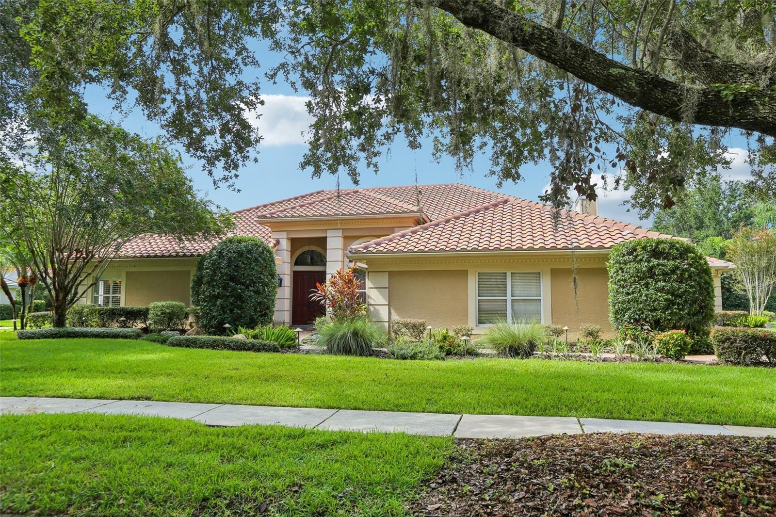 Prepare to live the ultimate Florida lifestyle in this magnificent 6-BEDROOM, 4.5-BATHROOM ESTATE, OFFERING OVER 4,400 SQUARE FEET of luxurious living space on a sprawling lot of NEARLY HALF AN ACRE. Perfectly positioned within the upscale, GATED COMMUNITY OF MAGNOLIA CHASE IN HUNTER’S GREEN, this home's design is both beautiful and practical, ideal for entertaining or daily comfort.
The journey begins as you enter into a bright, airy space defined by HIGH CEILINGS, FRESH PAINT, AND NEW LVP FLOORING. The home’s layout flows effortlessly from the formal living and dining areas into the heart of the home: a spectacular open-concept kitchen and family room. The showstopper kitchen is equipped with A 6-BURNER GAS STOVE, A STUNNING WOOD-FACED REFRIGERATOR, AND A MASSIVE CENTER ISLAND. A wall of sliders and convenient pass-through windows dissolve the barrier to the outdoors, creating a seamless connection to the lanai.
The expansive lanai, paved with elegant travertine, features a NATURAL GAS HEATED SALTWATER POOL AND SPA, A BUILT-IN OUTDOOR KITCHEN SPACE, and ample room for lounging and dining al fresco. The COZY GAS FIREPLACE in the adjacent family room ensures this entire space is the hub of activity, year-round.
When it's time to unwind, the luxurious primary suite offers a true escape, complete with a SPA-LIKE BATH FEATURING A GORGEOUS CUSTOM-TILED SHOWER. An ATTACHED SITTING ROOM  rounds out the beautiful suite. The home's clever SPLIT-BEDROOM FLOOR PLAN provides privacy and convenience for all, with FIVE ADDITIONAL BEDROOMS—including one with direct pool access, another with a private en-suite bath, and two connected by a Jack-and-Jill bath.
The expansive BONUS ROOM is the ultimate recreation center, featuring a BUILT-IN WET BAR, WINE FRIDGE, AND INTEGRATED SPEAKER SYSTEM, ready for movie nights or celebrating big wins. Practical features abound, including A 3-CAR SIDE-ENTRY GARAGE, A DURABLE TILE ROOF (2017), PLANTATION SHUTTERS, AND A WELL-APPOINTED LAUNDRY ROOM.
This is more than a home; it's a lifestyle in a location that can't be beaten. Enjoy convenient access to major highways, with a short 30-minute drive to Downtown Tampa. You are just moments from USF, Moffitt Cancer Center, other major hospitals and medical facilities, fantastic retail, diverse restaurants, and of course, the fabulous Hunter's Green Golf & Country Club. Don't miss this rare opportunity to have it all!