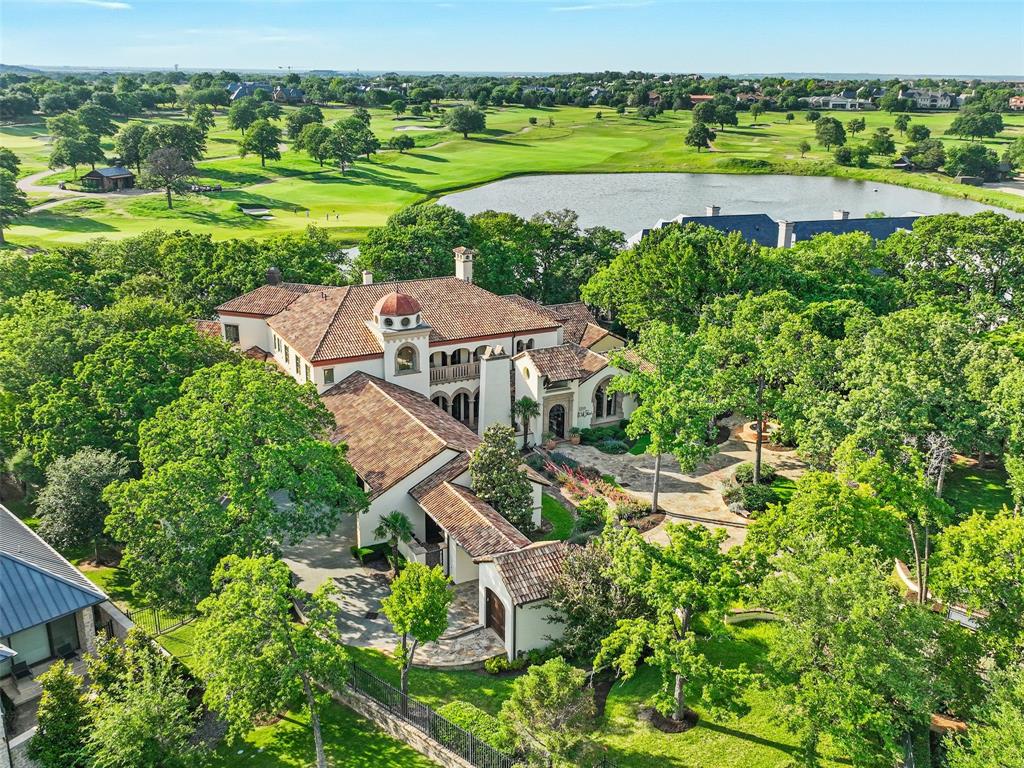 WOW!  Nestled within the coveted Private Enclave of Gated and Guarded community of Vaquero in Westlake, this extraordinary Estate is a RARE opportunity to own one of Westlake's MOST Breathtaking properties. Situated on a sprawling 1.6+acre Homesite, this exclusive residence offers unmatched privacy, serenity & spectacular Views overlooking a tranquil Pond & the picturesque 15th Hole of Vaquero’s Championship Golf course. From the moment you enter the private gate into the motor court, you are greeted to a private Courtyard featuring timeless Architecture & impeccable Craftsmanship. Rich in character & elegance & adorned with the highest quality Finishes throughout, this home reflects refined taste & sophisticated design. Features include flanking French doors from front to back w Breathtaking VIEWS, intricate Marble inlaid floors, Wood flooring, Venetian plaster, custom wood planked Ceilings and extravagant Cast Stone fireplaces.  The private Master Retreat boasts custom finishes including Bay Windows, custom Cast Stone fireplace, Wet Bar, marble flooring & countertops w Antique Mirrors + 2 sep closets. The 1st flr is equipped w 2 elaborate finished Studies, 2 Powder Baths, sub-grade Wine Cellar, Chef's Kitchen + Keeping Room, Elevator + spacious Laundry. Upstairs has 2 large private Bed Suites, Game-Media, Exercise and large Balcony Patio w unmatched Views. Attached to the home is a beautifully-detailed private Guest Quarters w bdrm, sitting area, kitchenette + laundry.  4 car + golf cart garage. Backyard of your dreams with outdoor Din-Liv, FP, Pizza Oven, Spa, Fire pit, Putting Green & tons of trees. This estate seamlessly blends indoor & outdoor Liv and expansive spaces designed for both grand Entertaining & intimate everyday moments. Enjoy Sunsets from the patio, relax by the Pond or take in the lush Golf course scenery at your own home. Every corner of this property offers a sense of peace & elevated living in one of the most Prestigious communities in Texas.