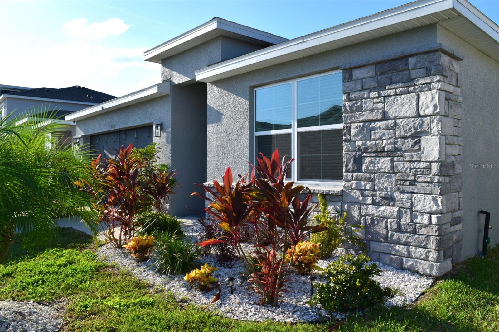 Nestled in the heart of the beautiful Epperson Lagoon community, this meticulously maintained 4-bedroom, 2-bathroom home offers an ideal combination of style, functionality, and comfort. With thoughtful features like an ADA-accessible bathroom, a beautifully extended screened-in lanai, and a smart home setup, this residence is designed to enhance your quality of life in every way. From the moment you step through the front door, you'll be greeted by an open, airy floor plan that flows effortlessly from room to room. The living area is bright and spacious, with natural light pouring in through the windows, offering views of the lush landscaping and tranquil pond outside. High ceilings and well-appointed finishes create an inviting atmosphere that feels both elegant and comfortable, perfect for everyday living or hosting guests. The primary bedroom is a true retreat, offering plenty of space to relax and unwind after a long day. Custom details abound in this room, including a stunning, built-in walk-in closet that offers ample storage and organization options. Whether you're a fashion enthusiast or simply enjoy keeping your space neat and tidy, this closet is sure to impress. For those who love to entertain or enjoy outdoor living, the extended screened-in lanai is a standout feature. With custom pavers that create a stylish and durable flooring solution, this outdoor space is perfect for enjoying Florida's beautiful weather year-round. The lanai is large enough to host family gatherings, dinner parties, or simply to enjoy a quiet evening in the fresh air. The entire backyard is enclosed with a privacy fence, ensuring that you can relax and enjoy your outdoor space in peace. Whether you have pets, children, or simply prefer the added security, the fenced-in yard provides an ideal setting for both play and relaxation!