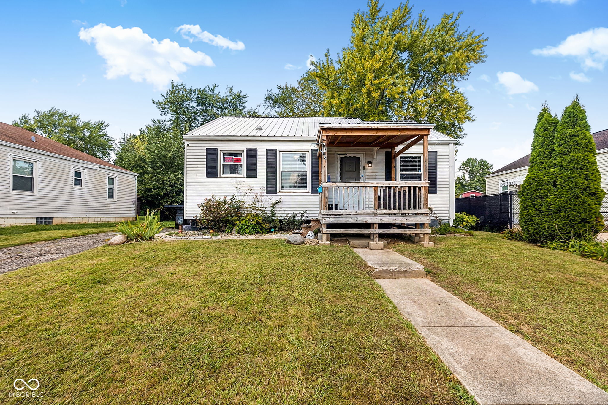 Discover the charm of 6702 E 18th ST, INDIANAPOLIS, IN, USA. This inviting single-family residence, built in 1957, offers 750 square feet of meticulously maintained living space, ready for immediate enjoyment. This property truly stands out for its thoughtful design and comfortable living.  The heart of the home, the kitchen, features a practical peninsula, perfect for casual dining or engaging conversations while preparing meals.  Relax and unwind in the living room, where a comforting fireplace creates a warm and inviting atmosphere, ideal for cozy evenings.  This appealing bungalow, with its single story, also includes a convenient basement, a private yard for outdoor enjoyment, a dedicated workshop space, and a welcoming porch.  This is more than a house; it's an opportunity to embrace a comfortable and fulfilling lifestyle.  This home also has an original Oil Tank in the basement.