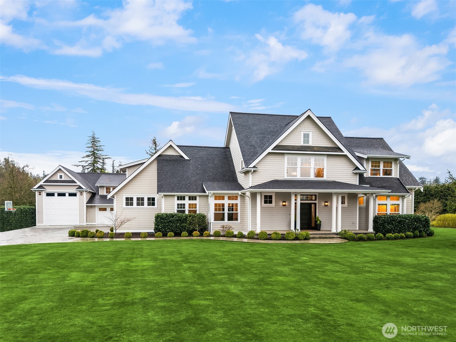 Rare Lynden estate with guest house on nearly 1 acre in a quiet cul-de-sac, offering luxury living, multigenerational flexibility, and investment potential near downtown Lynden and an easy drive to Bellingham. Built in 2018, this custom property includes a 3,500+ SF main home with 4 bedrooms, 4 baths, vaulted ceilings, open-concept living, abundant natural light, hardwood floors, designer tile, statement fireplace, chef’s kitchen with premium appliances, walk-in pantry, breakfast nook, bonus room for office, media, or gym, and attached garage. The separate ADU / guest house is fully independent with its own kitchen, living space, baths, and laundry, ideal for multigenerational living, guests, extended stay housing, or private work-from-home setup. Set on 0.81 acres of manicured, park-like grounds with lush lawn, curated outdoor living, room for gardening or play, separate driveways, abundant parking, and RV garage. Infrastructure includes shared well and dual septic systems. Enjoy privacy, space, and versatility with close access to Lynden schools, shops, restaurants, and everyday amenities. A rare Northwest Washington opportunity for buyers searching dual living, two homes on one property, guest quarters, luxury acreage, or flexible living near Lynden and Bellingham.