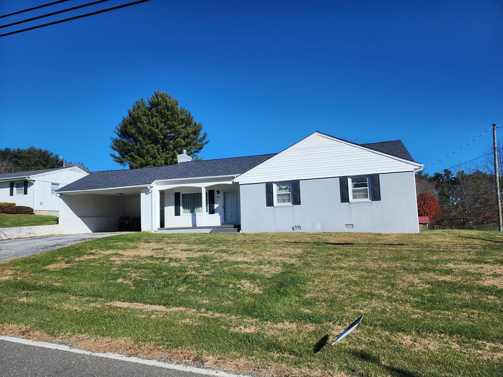 Very convenient brick and vinyl ranch home located in the center of Hillsville. Within walking distance to all amenities, including Main Street, shopping, banking, medical facilities, schools, wellness center, and worship centers. The home has 3 bedrooms, 2 bathrooms, living room with fireplace and remote control gas logs, dining room, and a large family room.  Hardwood, luminant, and ceramic tile flooring. Split unit heating and cooling and electric baseboard heat. All appliances and window dressing coney.  2 car attached carport, large rear stamped patio, and cellar.  Replacement windows throughout.  Small outbuilding. Large, open backyard. Paved driveway.