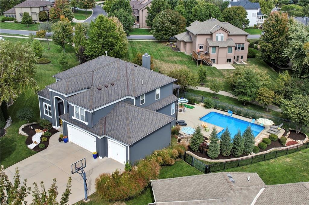 Resort-style living, exceptional entertaining spaces and extensive updates come together in this stunning Cedar Creek home. Perfectly positioned at the end of a cul-de-sac and backing to walking trails, the backyard oasis showcases a heated saltwater pool with a built-in rock wall, slide, two benches, a sun-shelf and fountains, along with a recently replaced composite deck—an upgrade exceeding $40,000. The wow factor continues inside with fresh interior paint, brand-new stair carpet & additional closet built-ins that enhance functionality.Significant recent updates include the roof, exterior paint, and a top-of-the-line HVAC system. The main level provides two separate office/flex spaces, including a front room that can function as a dining room or additional workspace, along with a secondary flex or sitting room with a second fireplace. The spacious living room showcases built-ins, a fireplace, and seamless connection to kitchen & outdoor living areas. Kitchen features include custom painted cabinetry, updated lighting, gas range, island seating, and walk-in pantry.The upper-level features engineered hardwood flooring throughout hallway and bedrooms, offering spacious secondary bedrooms along with a second primary suite. The finished walkout lower level is designed for entertaining, featuring a bar area with sink and refrigerator, third fireplace, ample recreation space and dual walkout access points leading to the outdoor retreat and pool area. Exceptional outdoor living with multiple entertaining spaces including a pergola-covered deck, hot tub, and expansive patio ideal for game tables & all within a fully fenced yard with three access gate including direct access to the walking trail. The oversized garage offers exceptional depth, width, and storage capacity. The neighborhood offers 3 swimming pools, pickleball, basketball and volleyball courts, walking trail, clubhouse amenities and close proximity to Cedar Niles Park, schools, shopping and highway access.