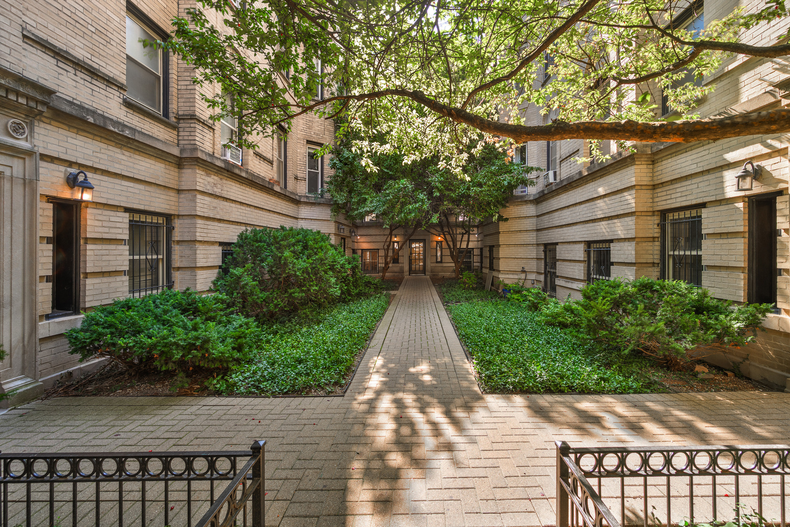 This one is a standout! Chic and timeless, this vintage condo is tucked into a quiet picturesque courtyard on tree-lined Pine Grove perfectly positioned where Lincoln Park and Lakeview meet, just a few blocks from the lake.  Where 1930s character meets modern design - original crown molding, arched doorways and built-ins, a decorative fireplace, hardwood floors and sleek updates make this 1400 square-foot home as spacious as it is stylish. An open, airy living room framed by courtyard trees is inviting and charming.  The adjoining formal dining room creates a welcoming space to gather and entertain with ease. Professionally designed and gutted in 2019, the kitchen is a true standout, featuring quartz countertops, top-of-the-line appliances, tile flooring, open shelving, custom cabinetry, and statement lighting. Tucked down a hallway from the living space, two large bedrooms, a bathroom, in-unit laundry and an enormous storage closet create a private living retreat. Rental parking is available close by. Walk to everything: public transportation, Trader Joes, Fresh Market, Stan's Donuts, Target, Lincoln Park, restaurants and bars, and so much more! With its spacious layout, vintage charm, and unbeatable location, this home is an absolute must-see!
