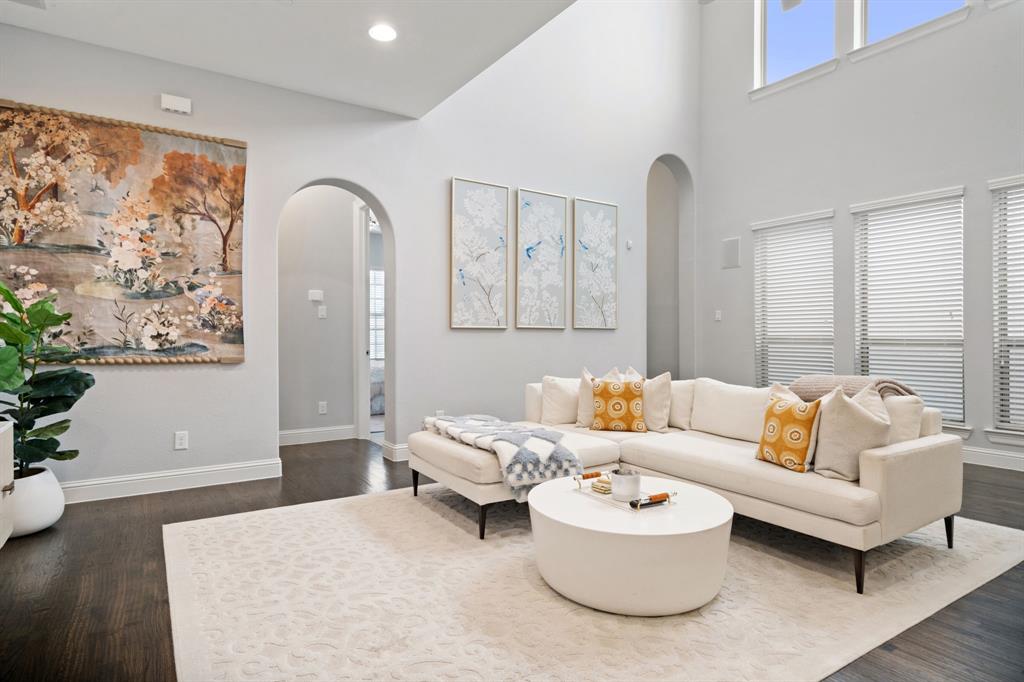 Sophisticated living in the heart of Las Colinas. Situated in the exclusive gated community of Vue Las Colinas, this 4-bed, 3-bath residence blends refined design with lock-and-leave convenience. The open layout showcases rich hardwood floors, soaring ceilings, and walls of windows for an abundance of natural light. The chef’s kitchen features premium stainless steel appliances, a gas cooktop, stone backsplash, and an oversized island perfect for entertaining. A main-level guest suite offers comfort and privacy, while the serene upstairs primary retreat boasts a spa-inspired bath and generous walk-in closet. Enjoy a low-maintenance yard and an unrivaled location steps from the Ritz-Carlton golf course, Toyota Music Factory, and the best of Las Colinas.